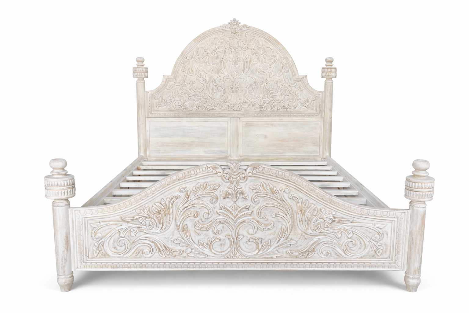 Wite background image of a hand carved white washed Mango wood bed frame in mediterrane style.