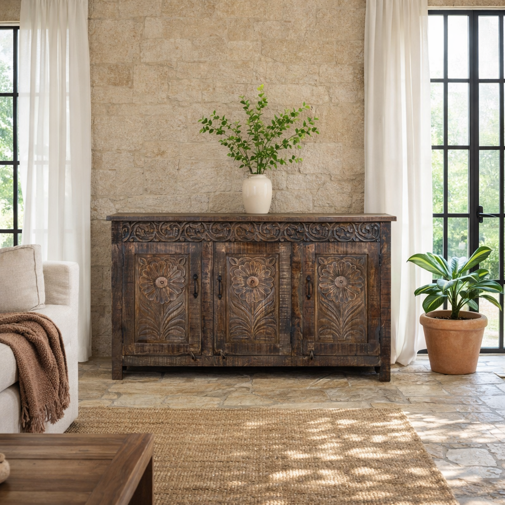 Lifestyle image of a dark brown hand carved mango wood sideboard with floral design and ample storage.