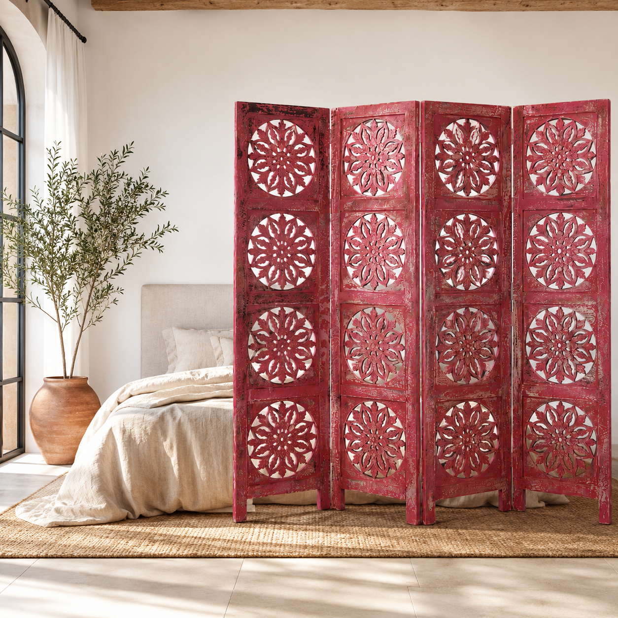 Lifestyle image of a hand-carved pink mango wood folding room divider with delicate carved patterns, natural variations, and warm boho style for unique interiors.