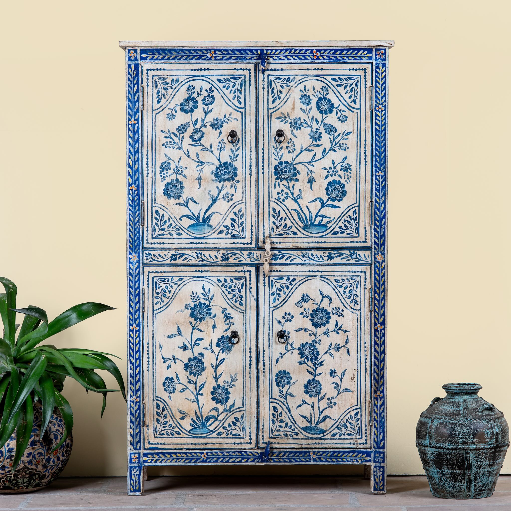 Image of a unique hand painted wardrobe made of reclaimed wood with floral design, 4 doors and ample storage.