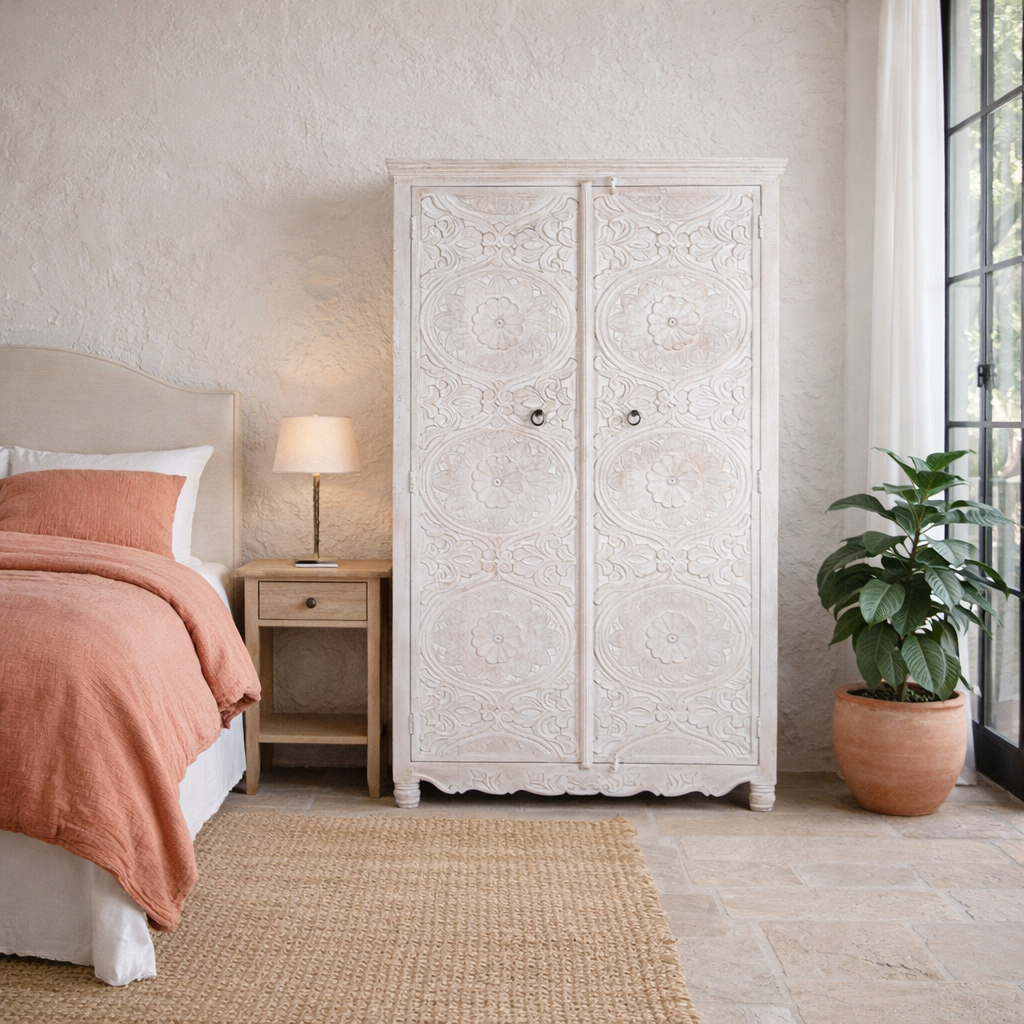 Lifestyle image of a hand carved white washed mango wood wardrobe in vintage design.