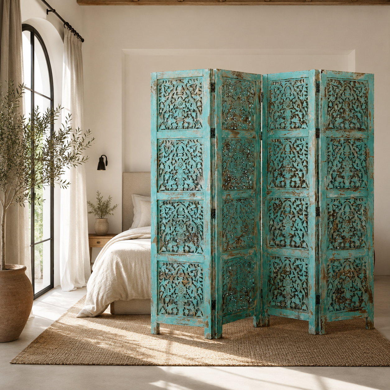 Lifestyle image of a hand-carved green mango wood folding room divider with delicate carved patterns, natural variations, and warm boho style for unique interiors.