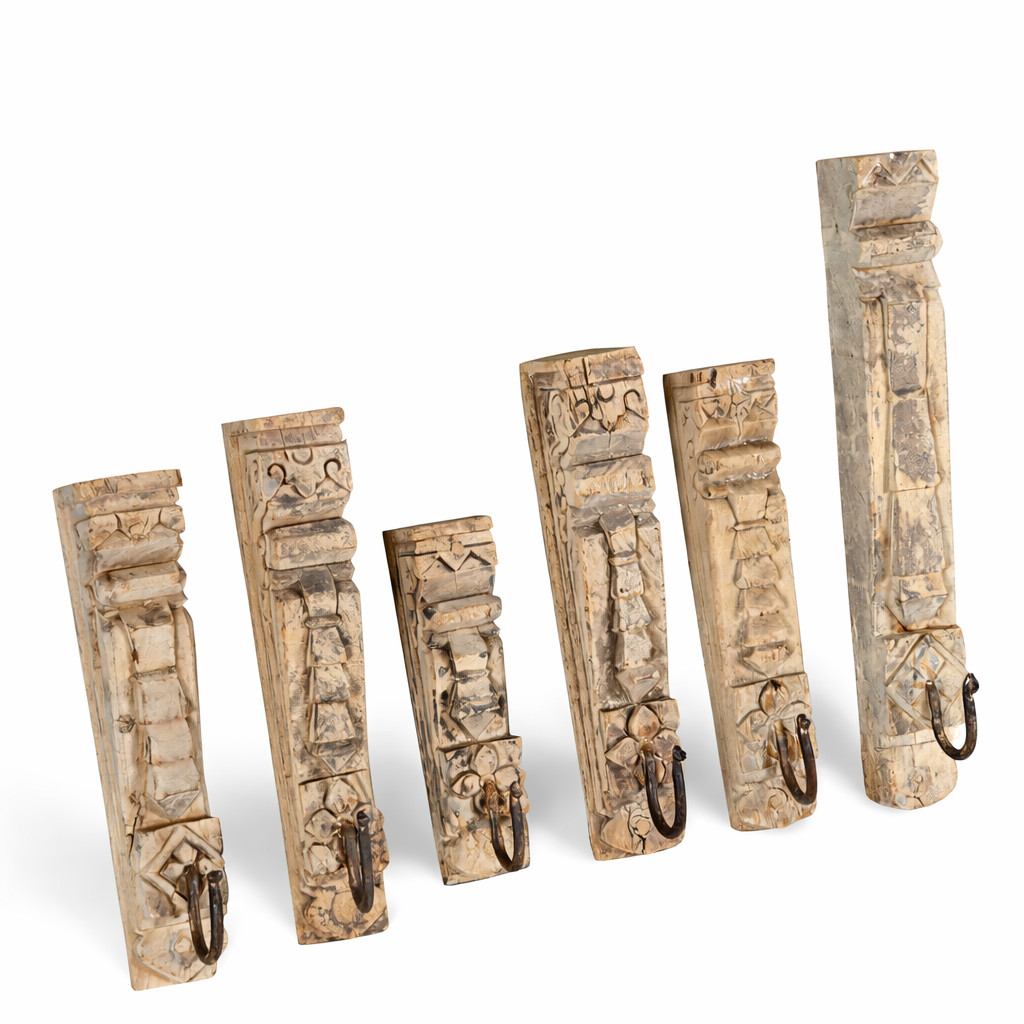 White background image of a hand-carved teak wood wall hooks Mahin made from antique house parts with mixed carvings and aged patina. A vintage home accessory and unique Indian decoration perfect for vintage home decor in entryways or bathrooms.
