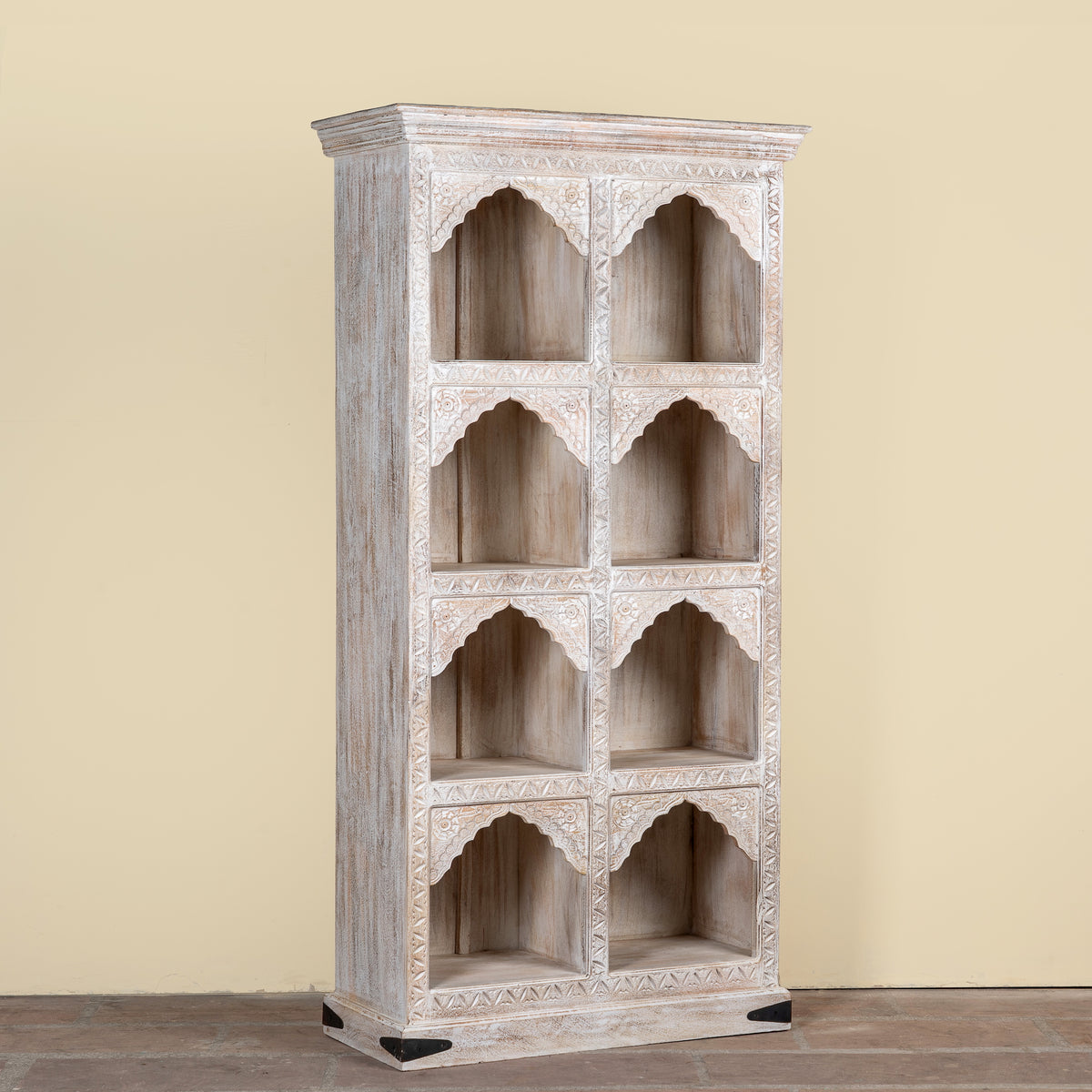 Image of a hand-carved mango wood shelving unit with Moroccan arches and whitewashed finish; perfect as an entryway shelf or display piece, 180 × 90 × 40 cm.