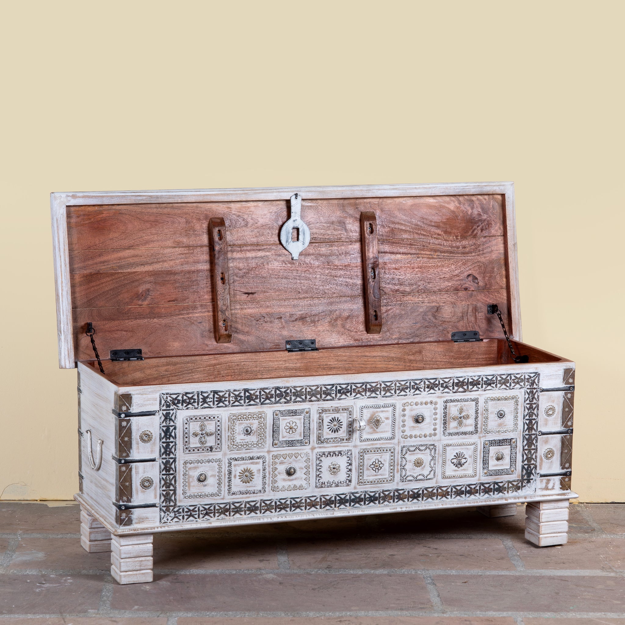 Image showing open lid of a Aryav whitewashed mango wood coffee table chest with decorative iron fittings 116cm