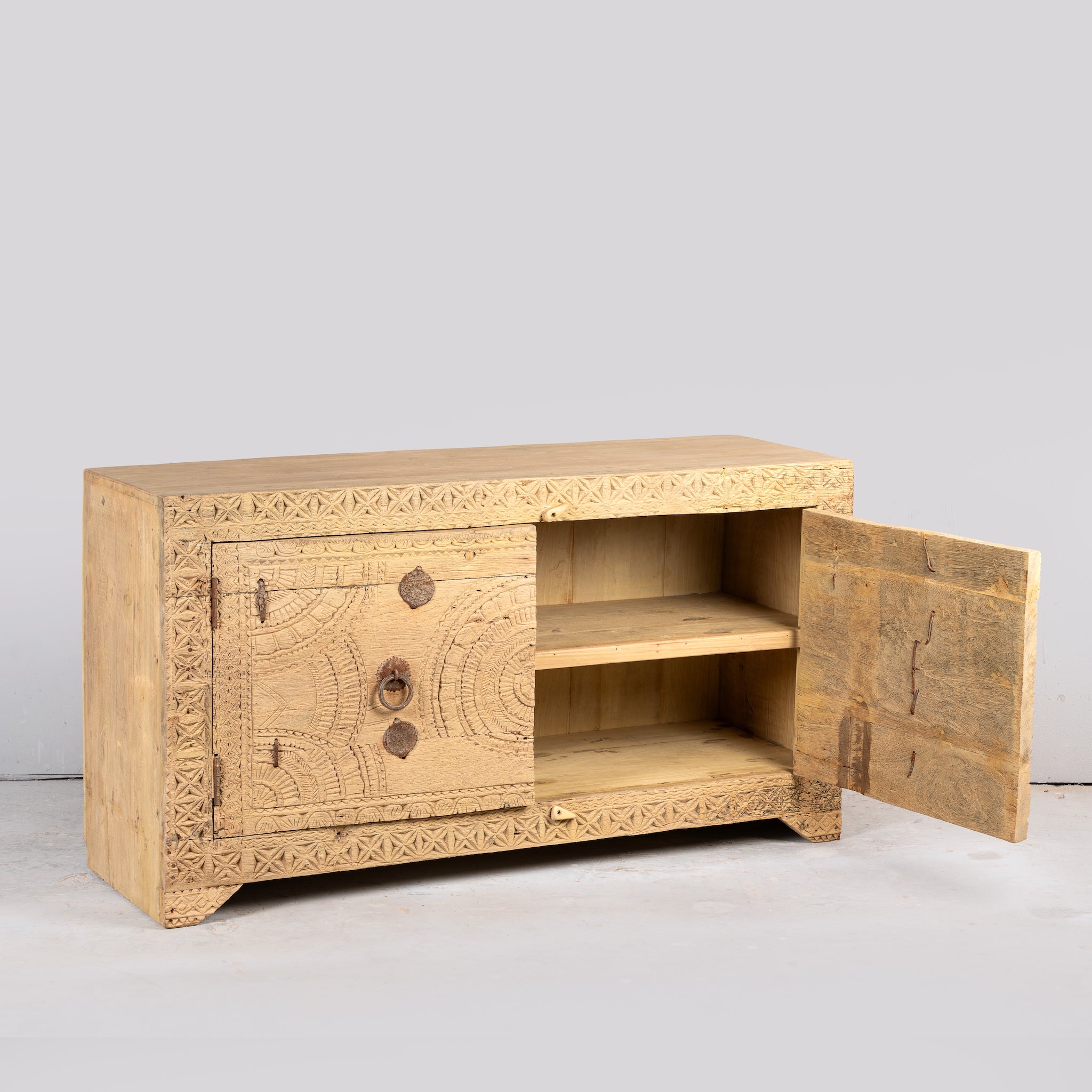 Side angle image with open door of a Ayra reclaimed teak wood sideboard with hand carved Orissa house door elements and original iron fittings 123cm