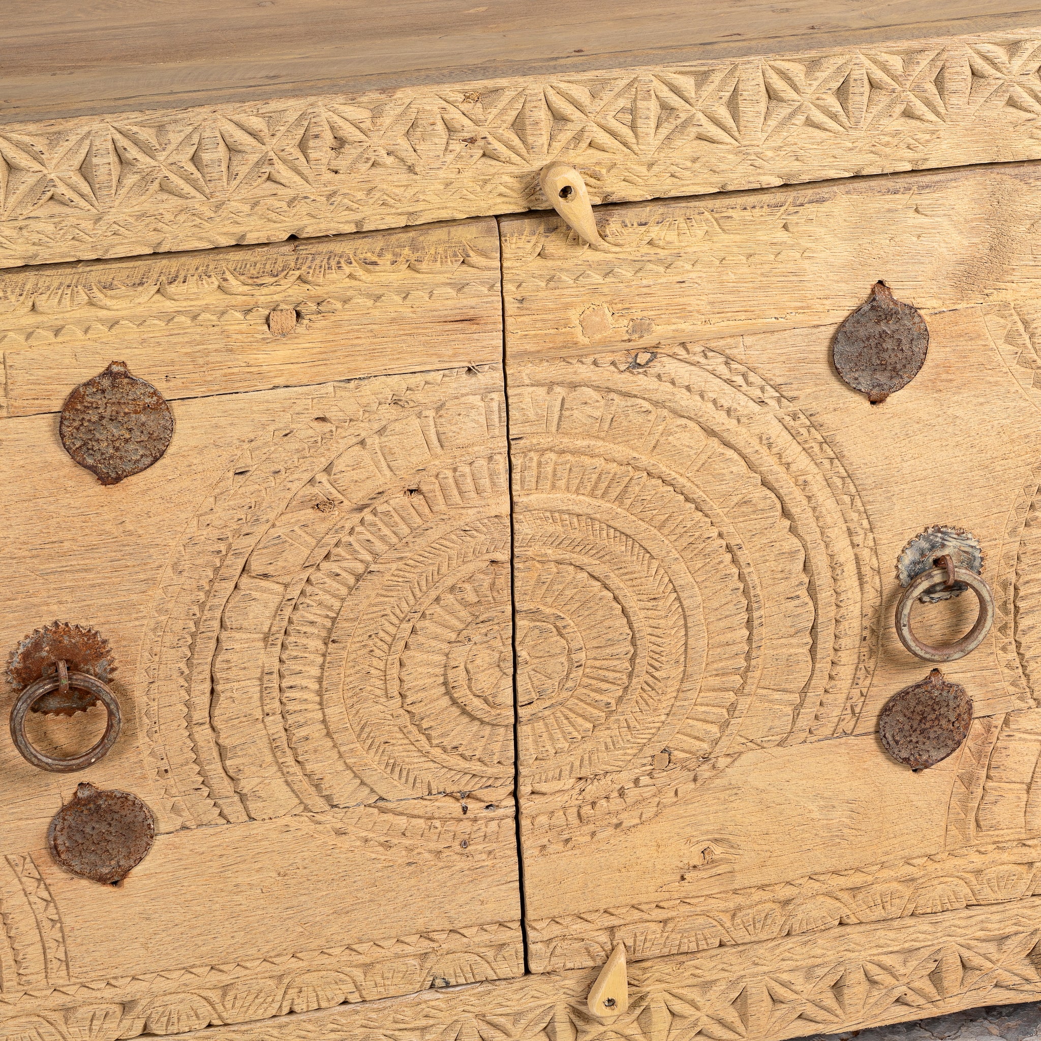 Close up image of a Ayra reclaimed teak wood sideboard with hand carved Orissa house door elements and original iron fittings 123cm