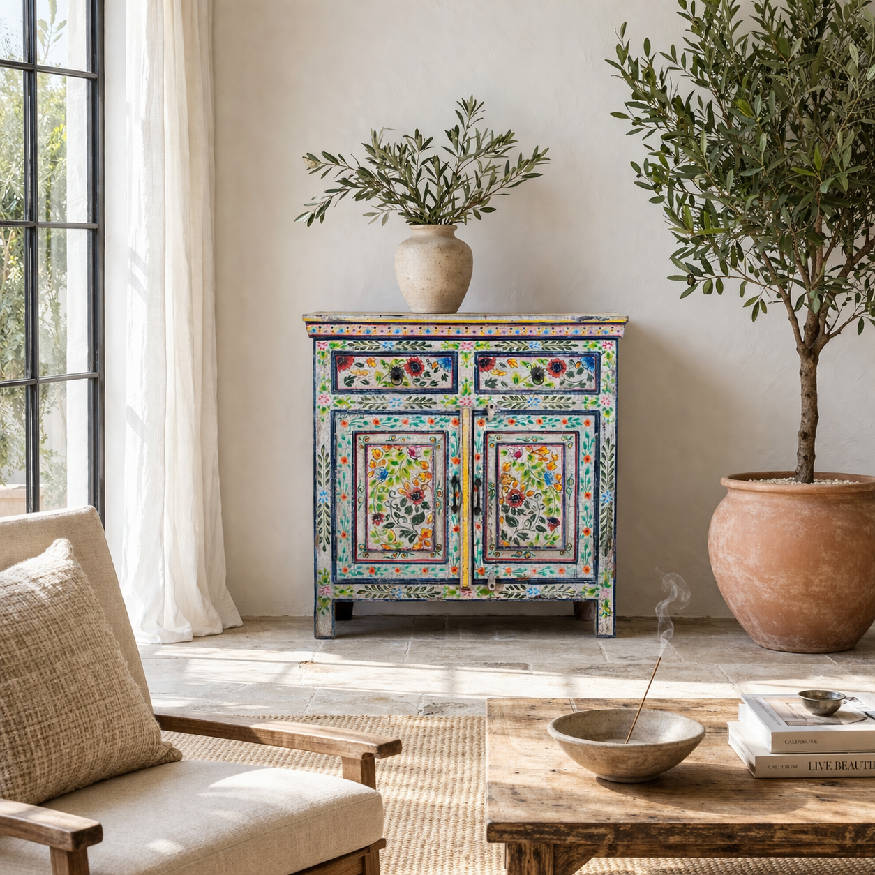 Lifestyle image of a hand painted reclaimed wood storage cabinet in vintage floral design.