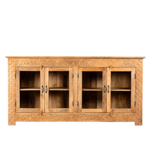 White background image of a hand-carved wooden showcase Barot made from natural mango wood, featuring detailed floral carvings across its front. A sustainable piece of Indian furniture online ideal for living room furniture with a Mediterranean and boho-style design.