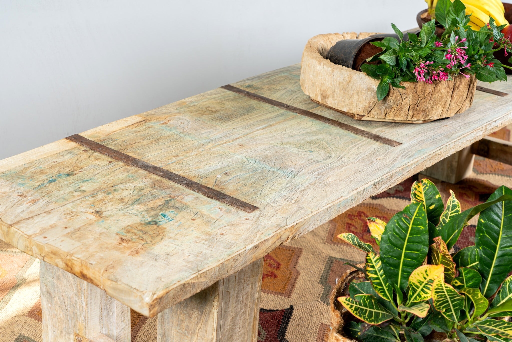 Close up image of a Beas handcrafted bench made from a reclaimed antique Indian half teak door with original iron fittings, solid teak wood construction, rustic Ibiza style, and versatile bench or table design, 170cm.