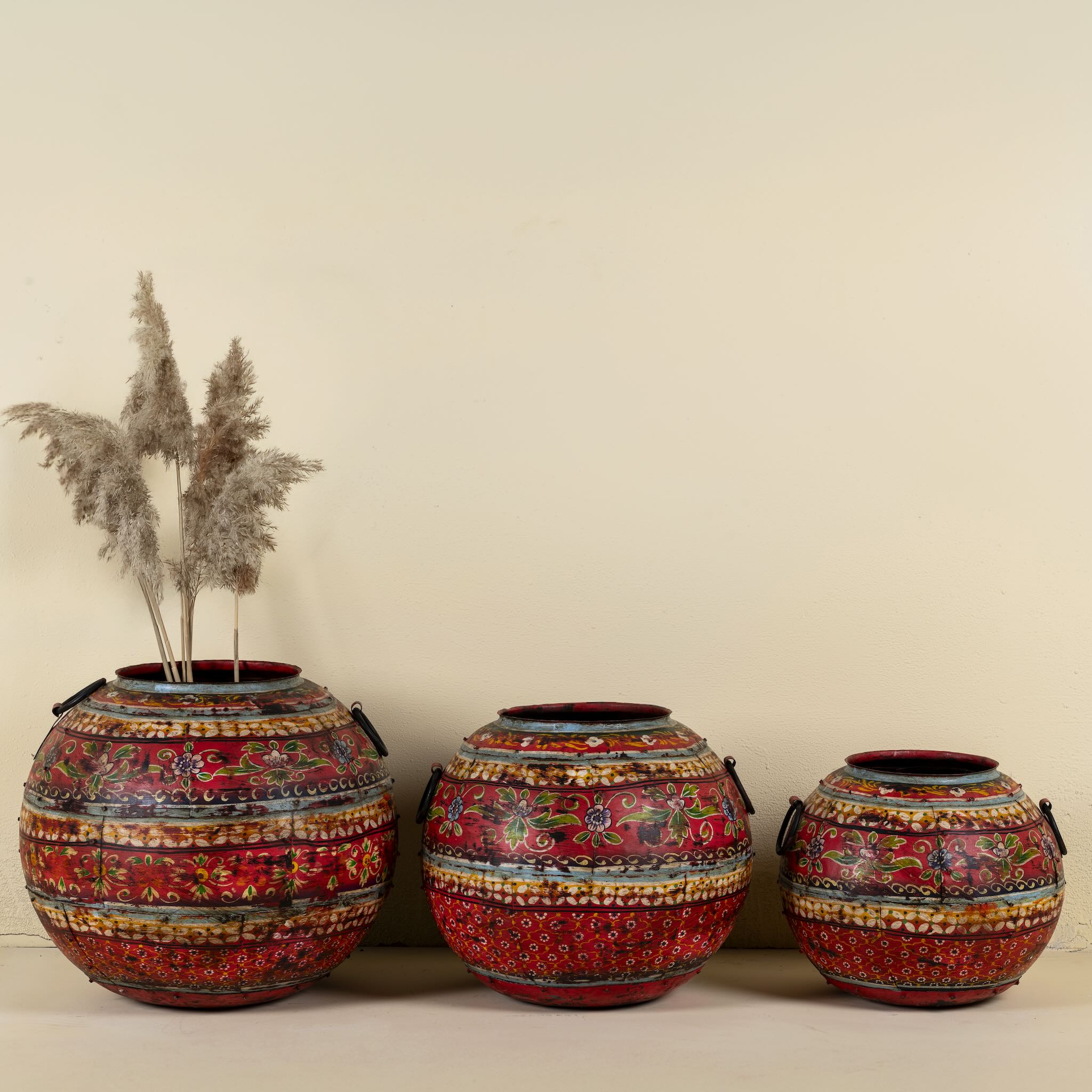 Set of 3 round hand-painted iron pots with silver floral designs on blue background, artisanal Indian home accessories and vintage decor accents.