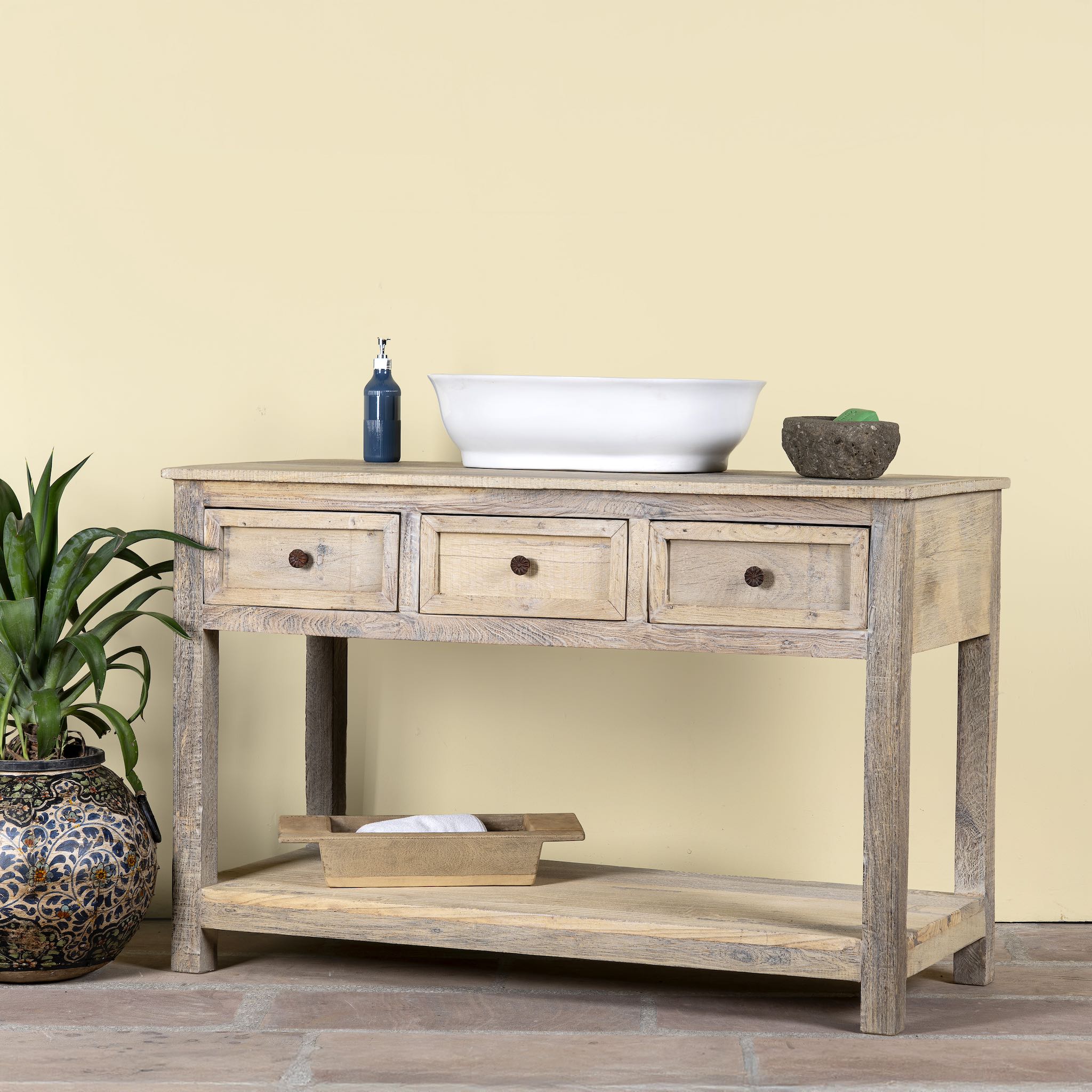 Side angle image of a sandblasted reclaimed wood bathroom console table with 3 drawers and open shelf; sustainable furniture, 120 × 50 × 80 cm.