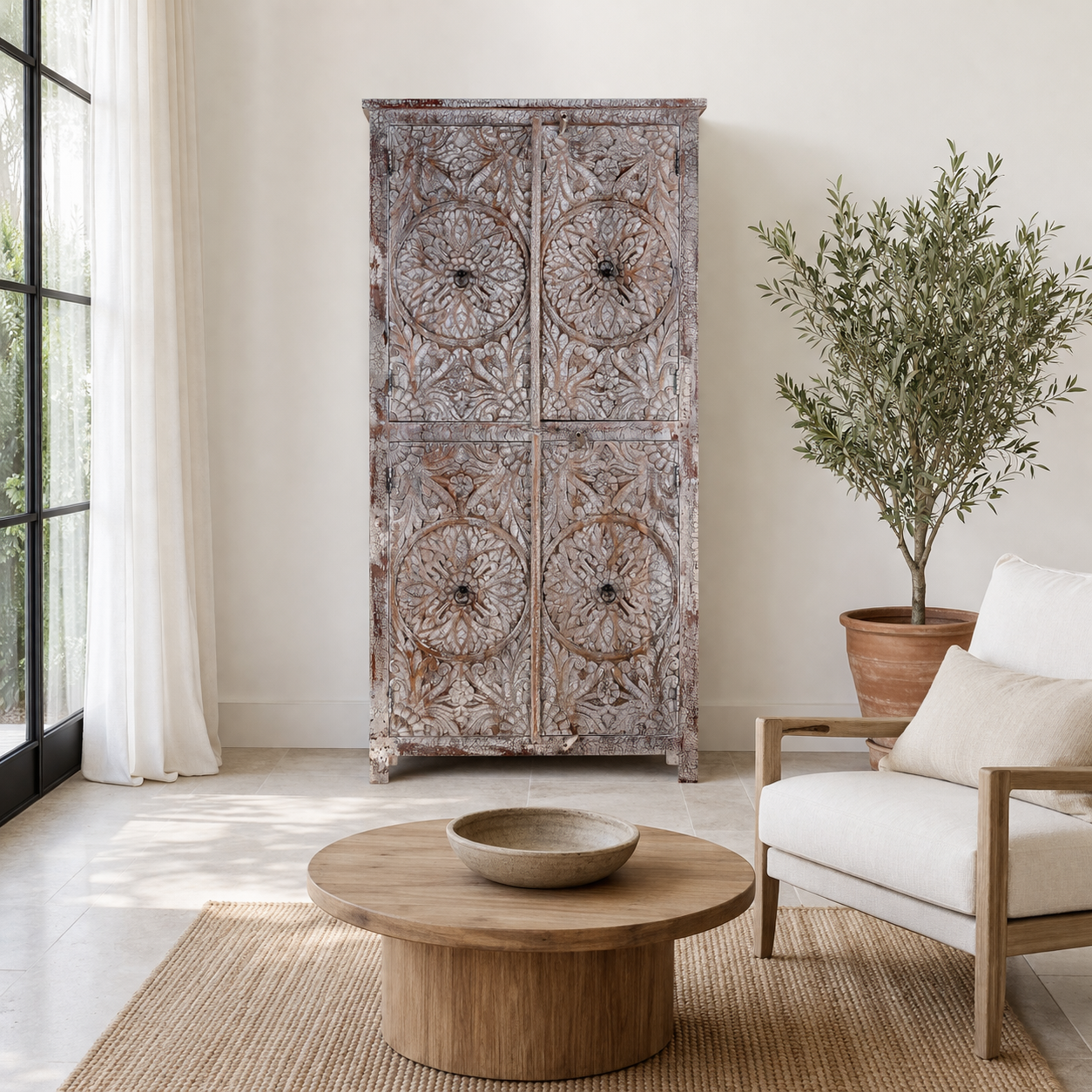 Lifestyle image of a hand-carved acacia wood wardrobe with floral detailing and distressed finish – vintage living room furniture with artisan craftsmanship.