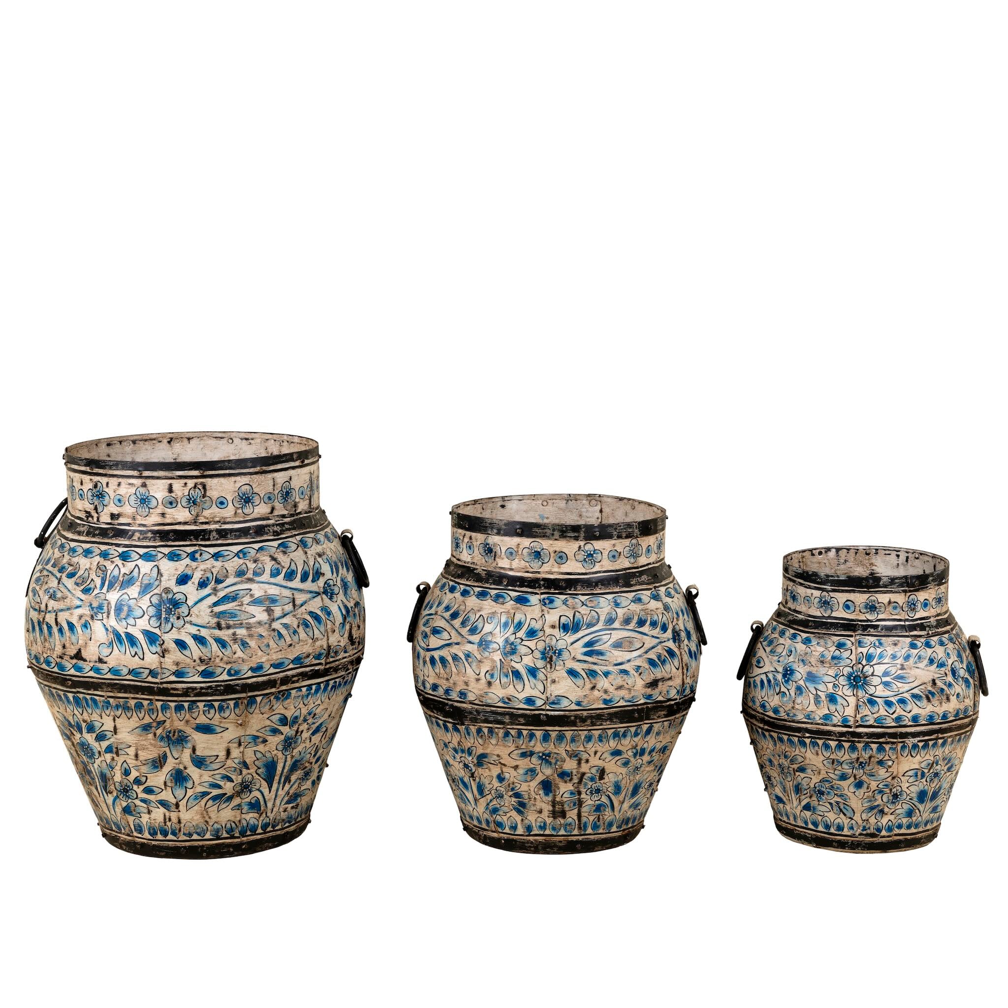 White background image of a set of 3 hand-painted decorative iron pots in cream and blue floral designs, featuring traditional Indian motifs – perfect for vintage home accessories and painted iron decoration.