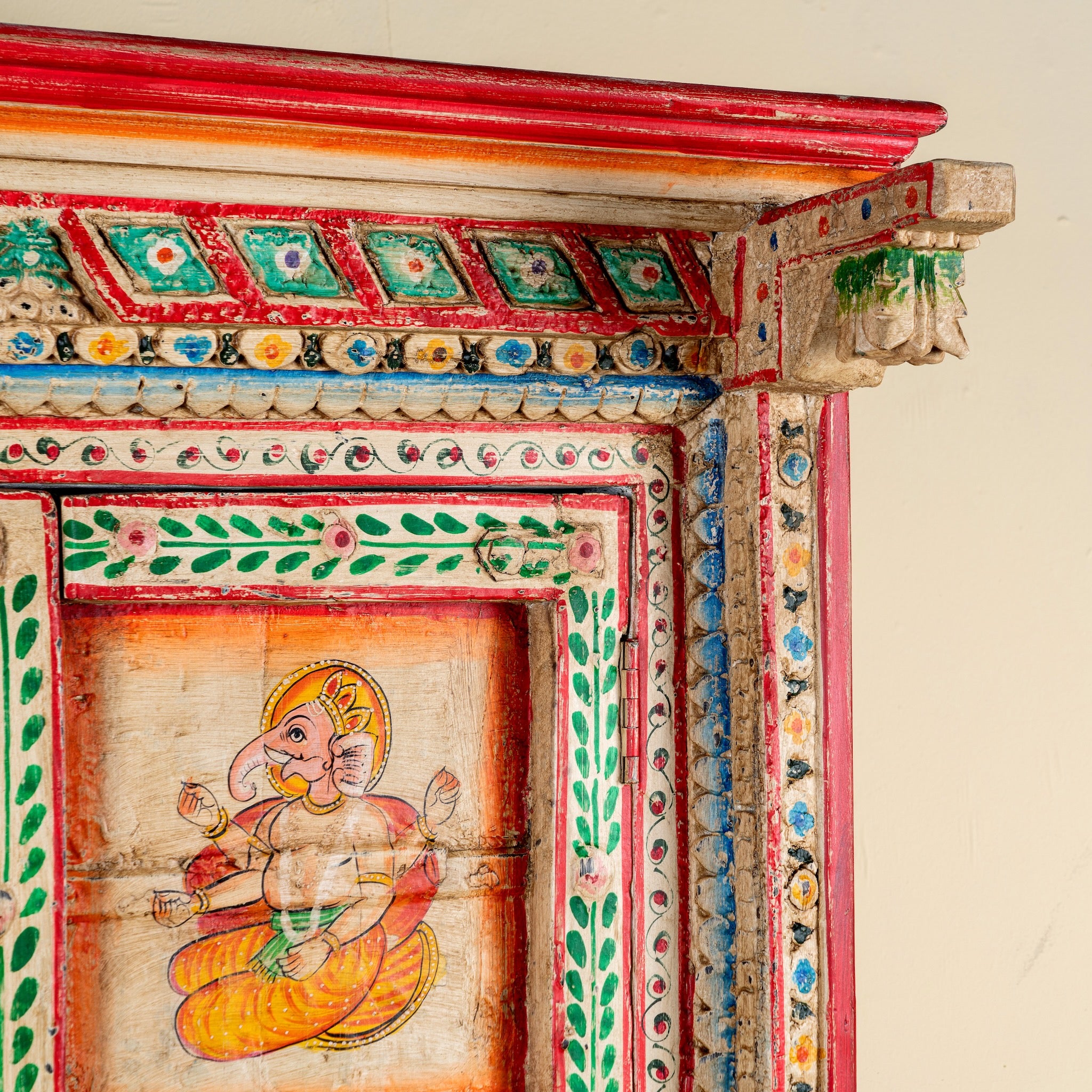 Close up image of a antique hand painted wardrobe made from reclaimed teak wood with Indian motifs; unique furniture and teak wood furniture, 113 × 50 × 190 cm.