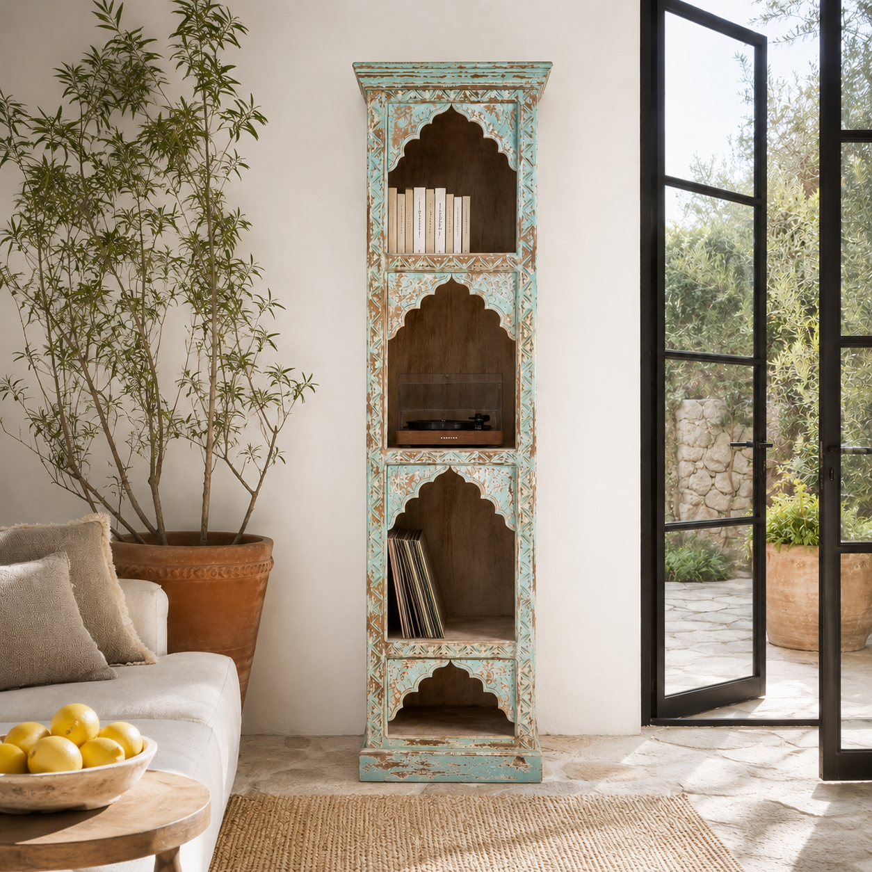 Lifestyle image of a hand-carved mango wood bookshelf with oriental detailing and natural wood finish – carved wooden furniture and vertical shelving for refined, rustic interiors.