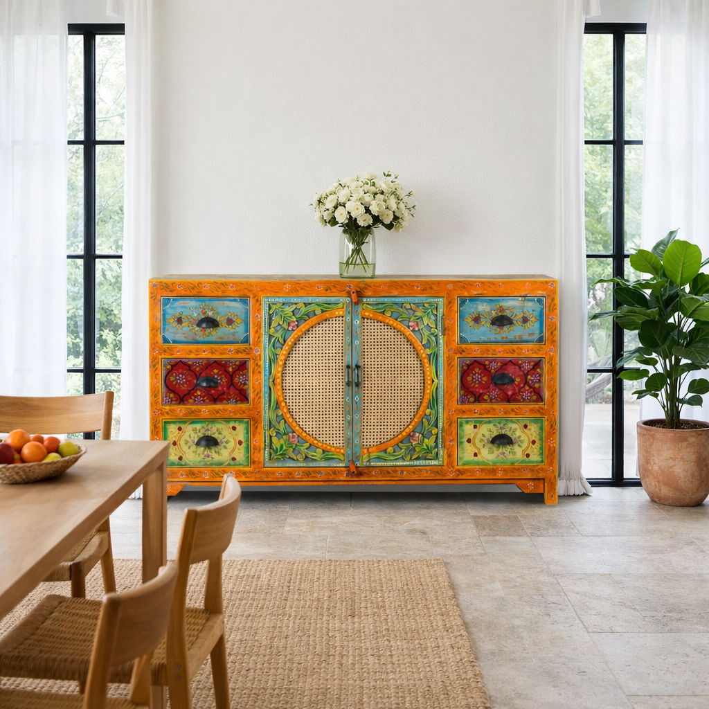 Lifestyle image of a vintage style furniture sideboard with hand-painted floral motifs and rattan door inserts, bohemian rattan door furniture, 160 × 40 × 90 cm.