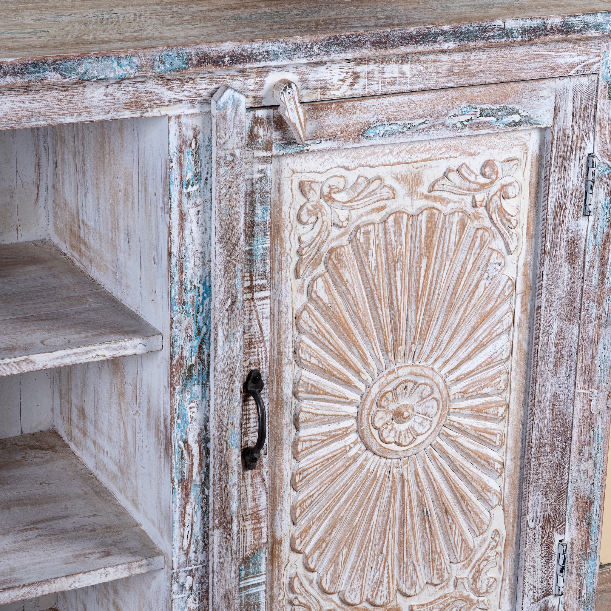 Close up image of a Devesh reclaimed wood sideboard with hand carved refurbished doors, open shelves and vintage whitewash finish 153cm
