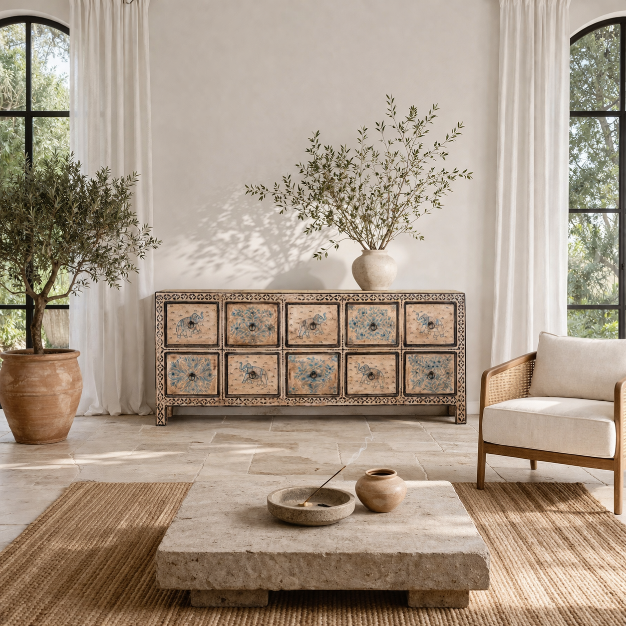 Life style imagination of a hand painted mango wood chest of 10 drawers with elephant and floral motifs; hand painted furniture for a boho chic living room, 200 × 41 × 85 cm.