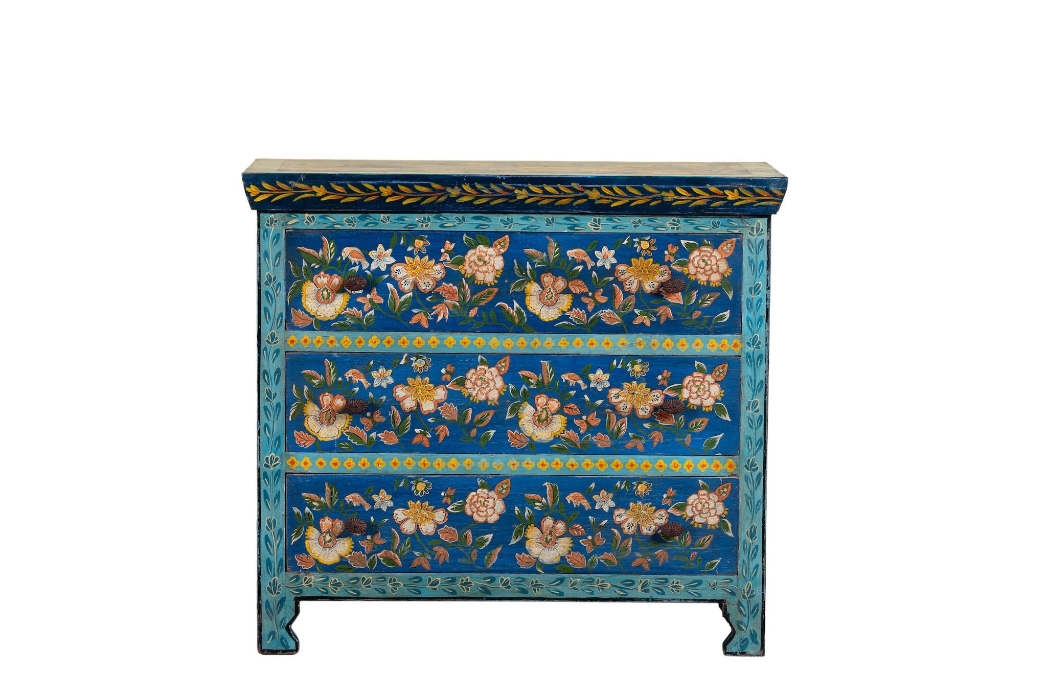 White background image of a hand-painted cupboard made of reclaimed wood with floral drawer fronts – Divisha model by Om Home & Garden