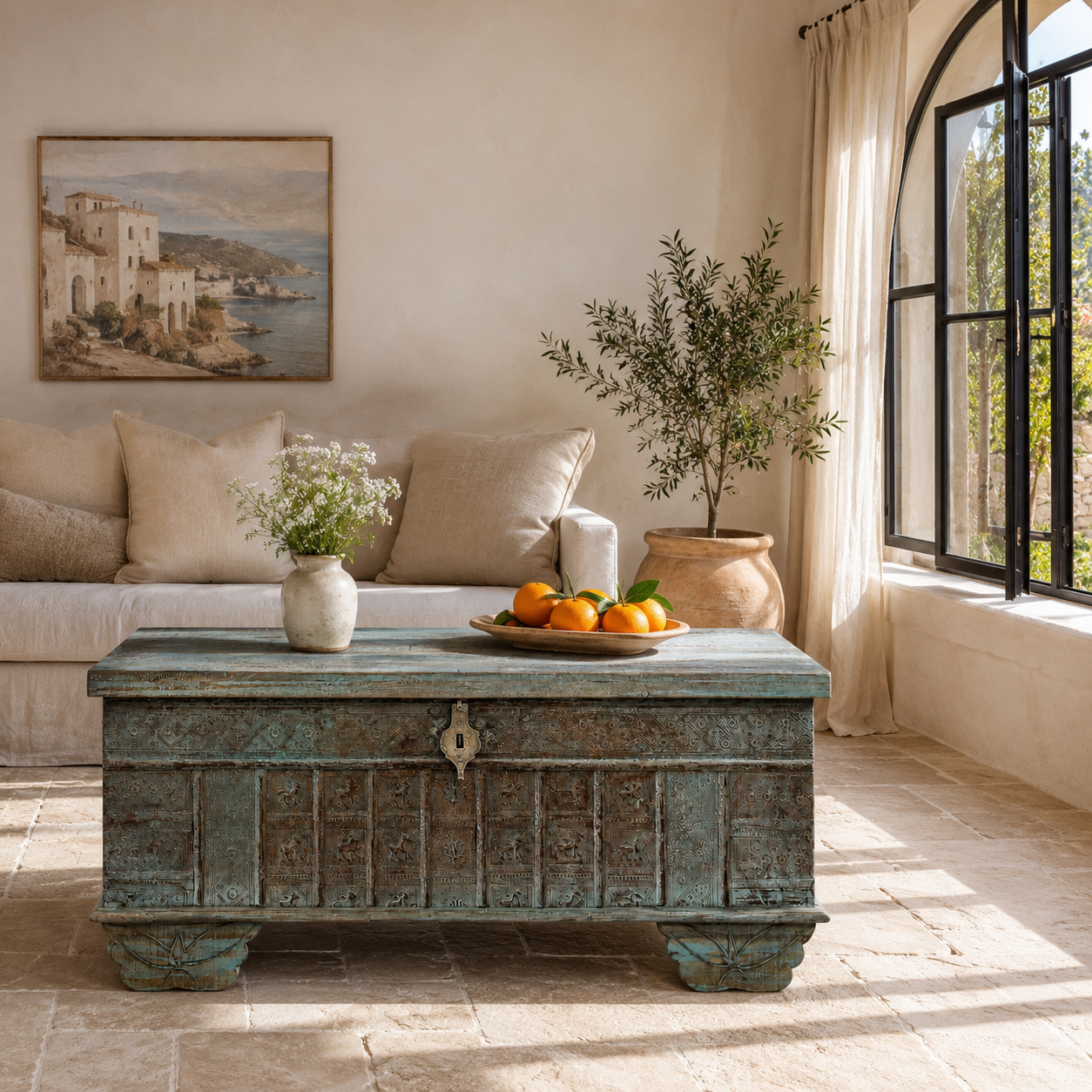 Lifestyle image of a antique Indian chest coffee table in blue with brass fittings – iron fitted wooden chest made from solid teak, ideal for living rooms with storage space.