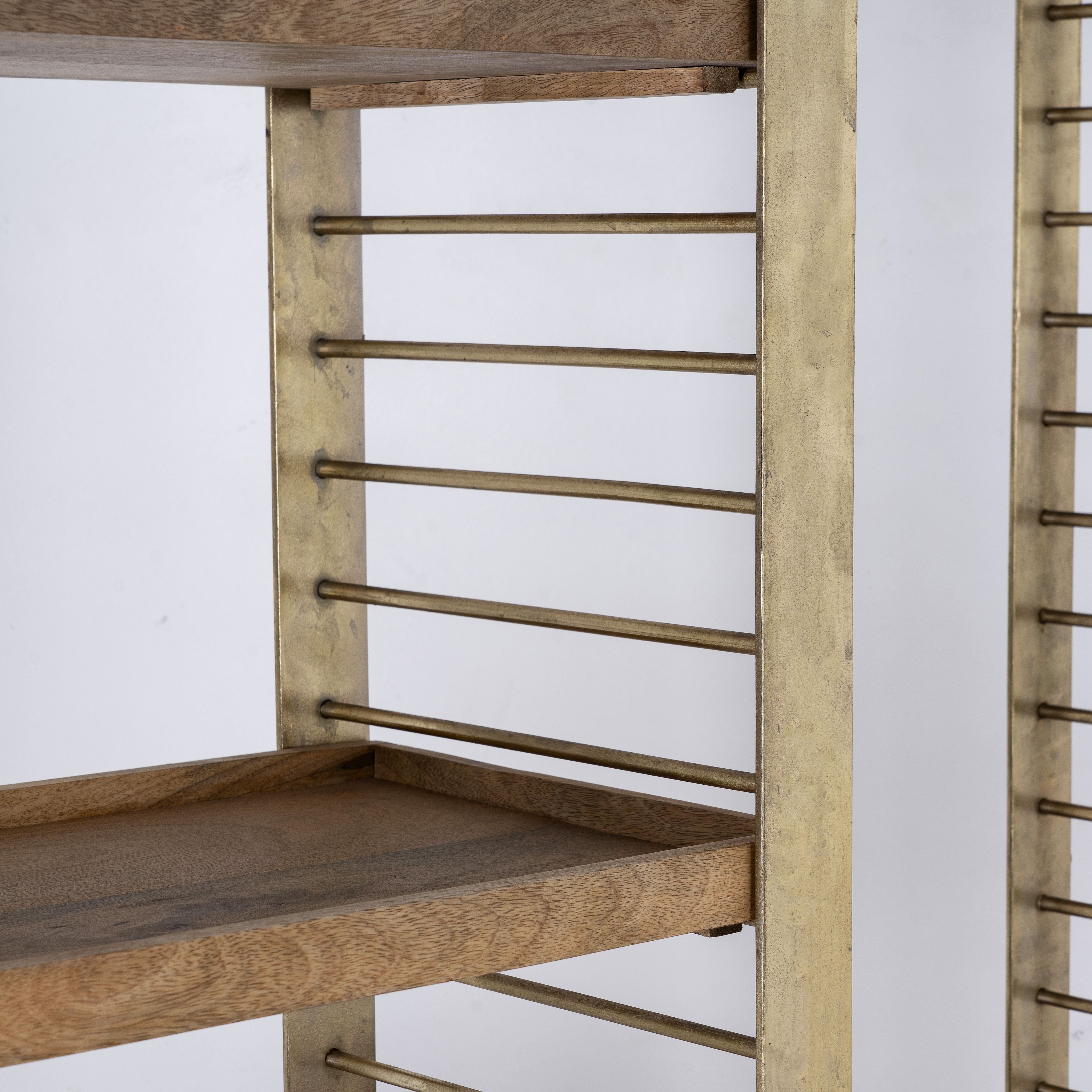 Close up image of a modular brass-plated iron shelf with removable mango wood trays – minimalistic furniture and mango wood shelving for modern, practical interiors.