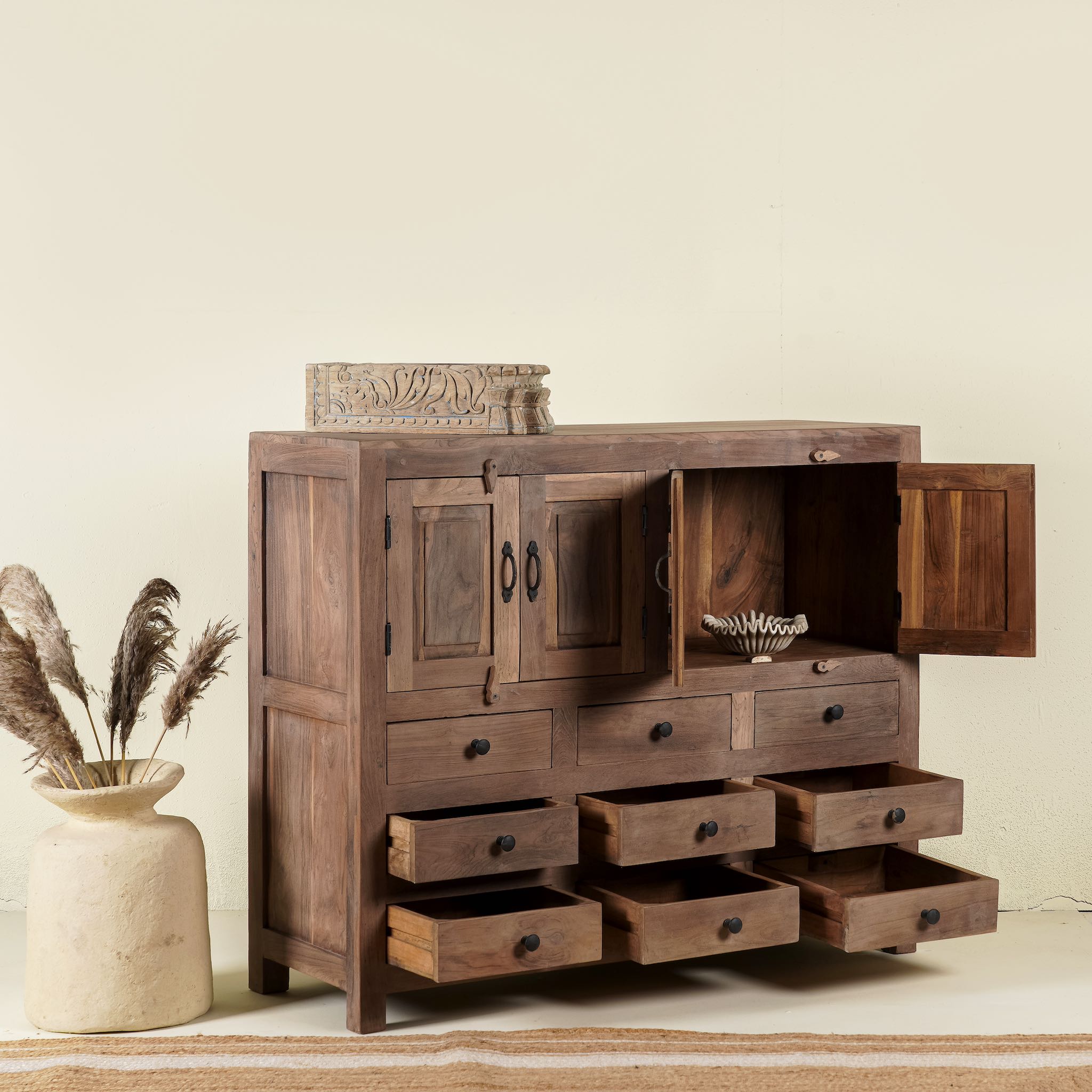 Side angle image with open doors of a sustainable furniture teak sideboard made from reclaimed old teak wood in Ibiza style, 120 × 40 × 100 cm.