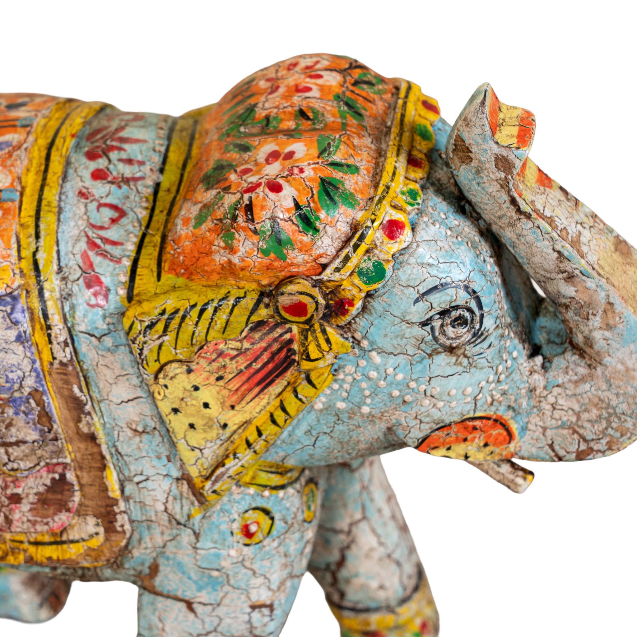 Close up image of a hand‑painted wooden elephant decoration with colourful folk art motifs, a unique Indian home accessory and vintage home decor accent.