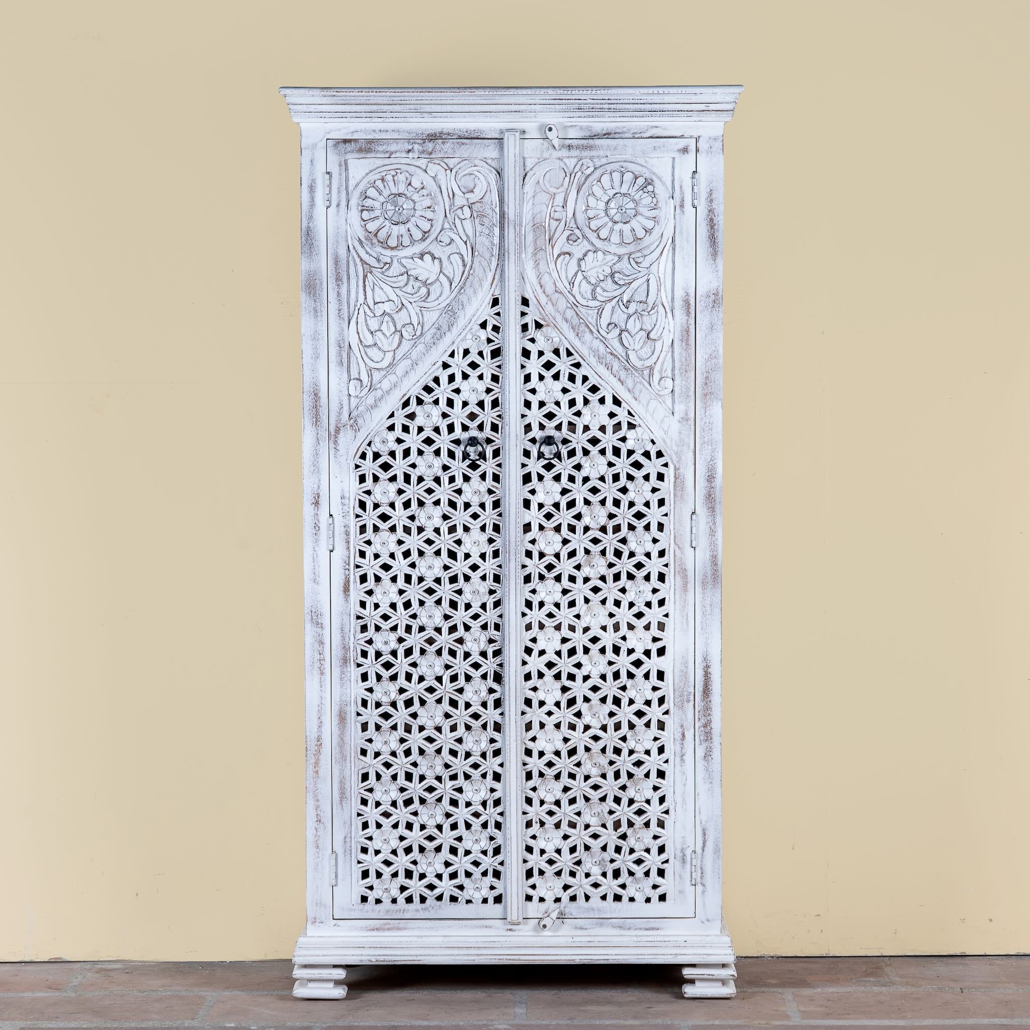 Image of a white-washed hand-carved wooden wardrobe made of solid mango wood, vintage furniture with Mediterranean Ibiza style, 180 × 90 × 40 cm.
