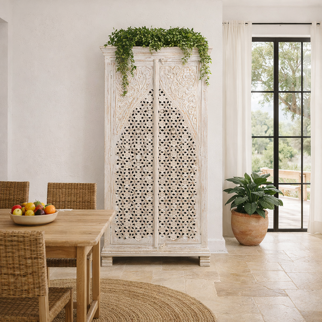 Lifestyle image of a white-washed hand-carved wooden wardrobe made of solid mango wood, vintage furniture with Mediterranean Ibiza style, 180 × 90 × 40 cm.