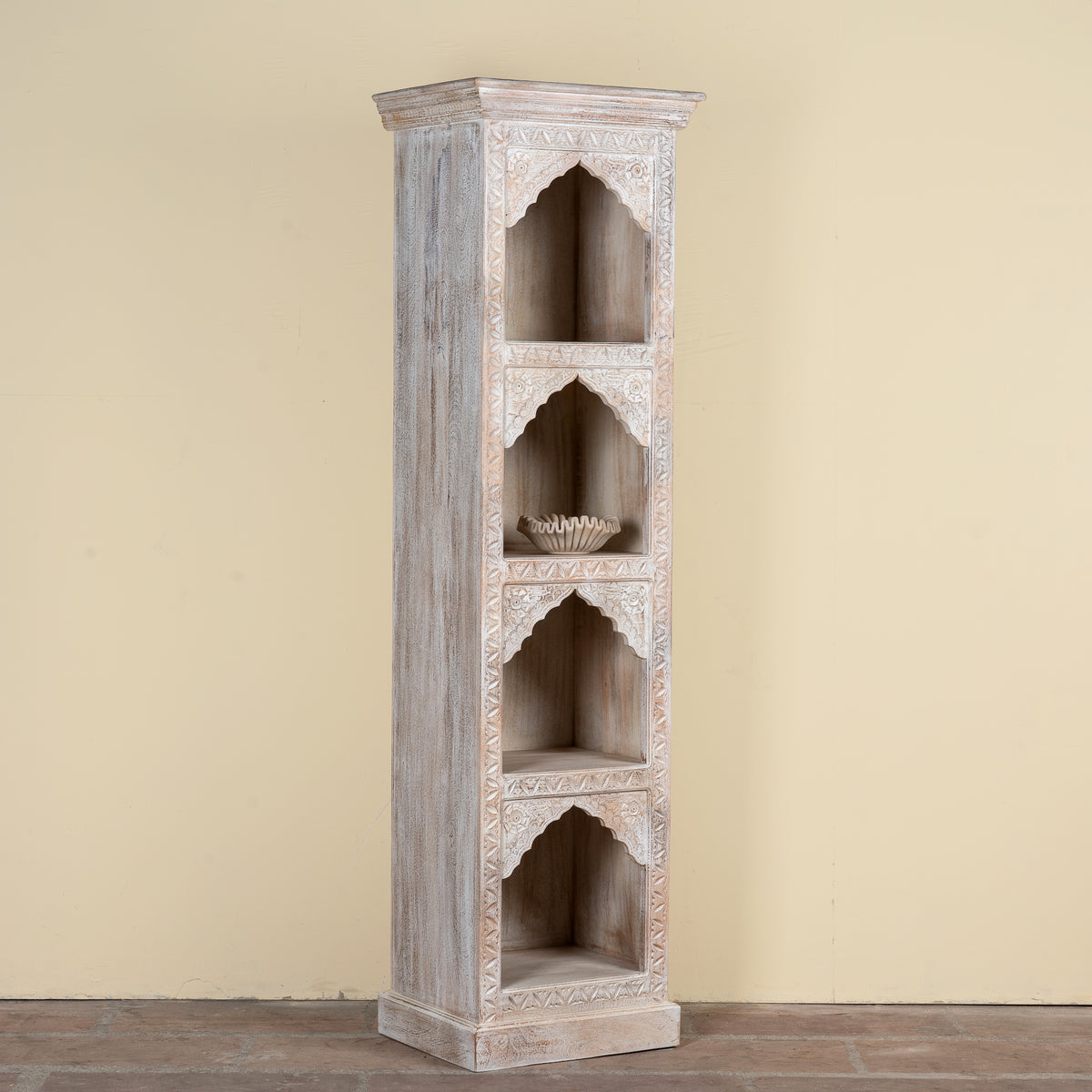 Side angle image of a hand-carved mango wood bookshelf with oriental detailing and natural wood finish – carved wooden furniture and vertical shelving for refined, rustic interiors.