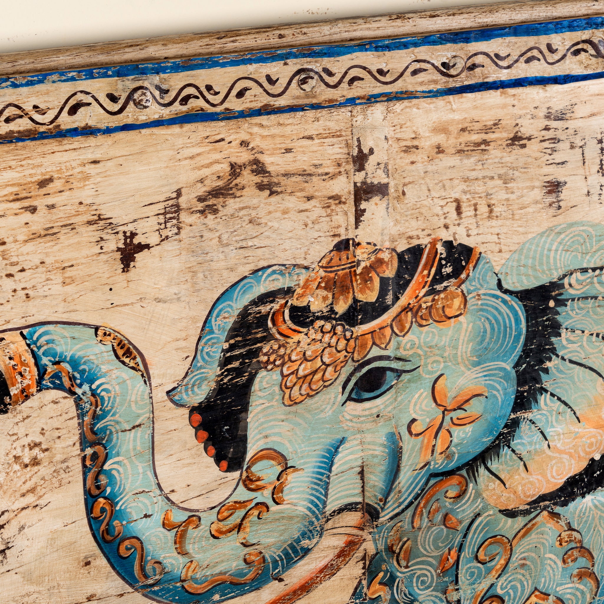 Close up image of a Hridaan vintage teak wood wall panel with hand-painted elephant artwork and authentic aged finish, 175x5x78cm.