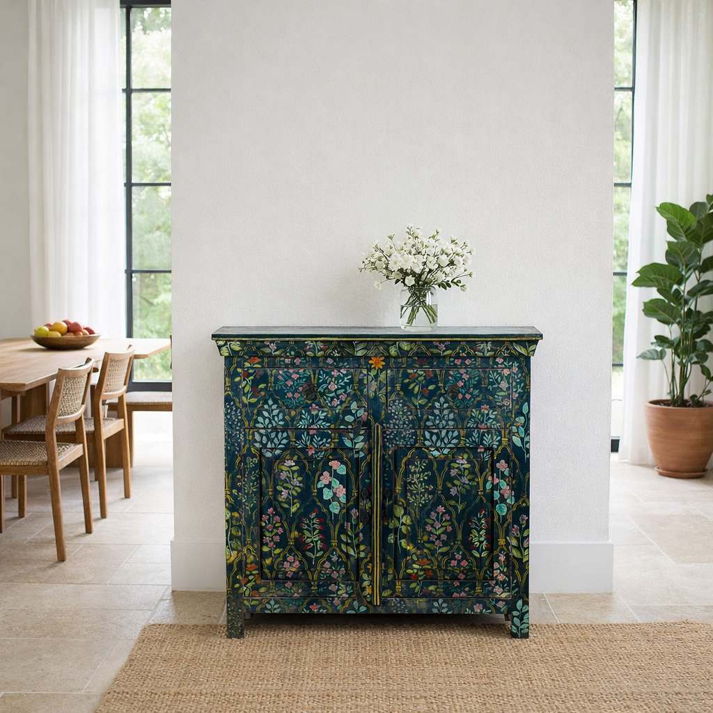 Lifestyle image of a hand painted cupboard made from recycled wood with floral motifs, two drawers and two doors, 90 × 90 × 40 cm.
