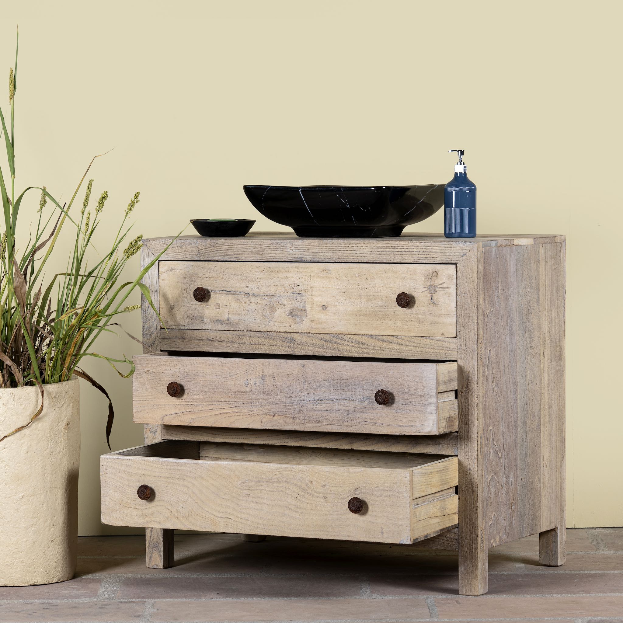 Image with open drawers of a reclaimed wood chest of 3 drawers with rustic finish and round knobs; Ibiza style sustainable furniture, 90 × 50 × 80 cm.