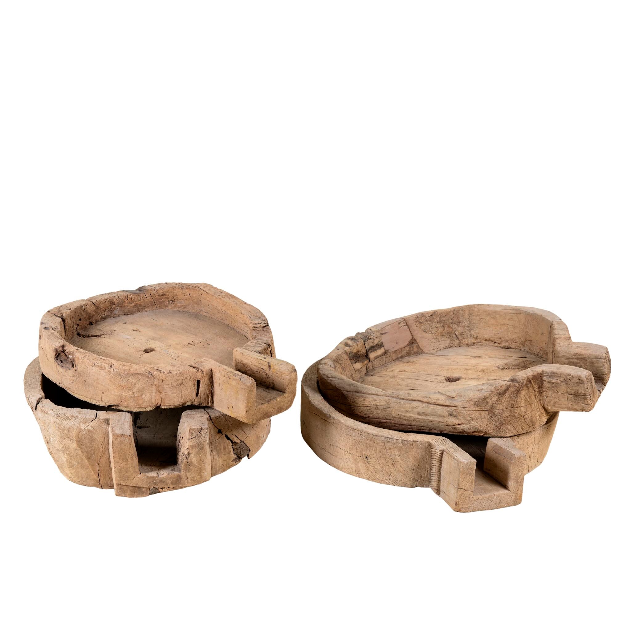 White background image of an antique teak wood oil grinder Jai with natural patina and hand-carved form. A vintage home accessory and unique Indian decoration ideal as a planter or entryway piece in vintage home decor settings.