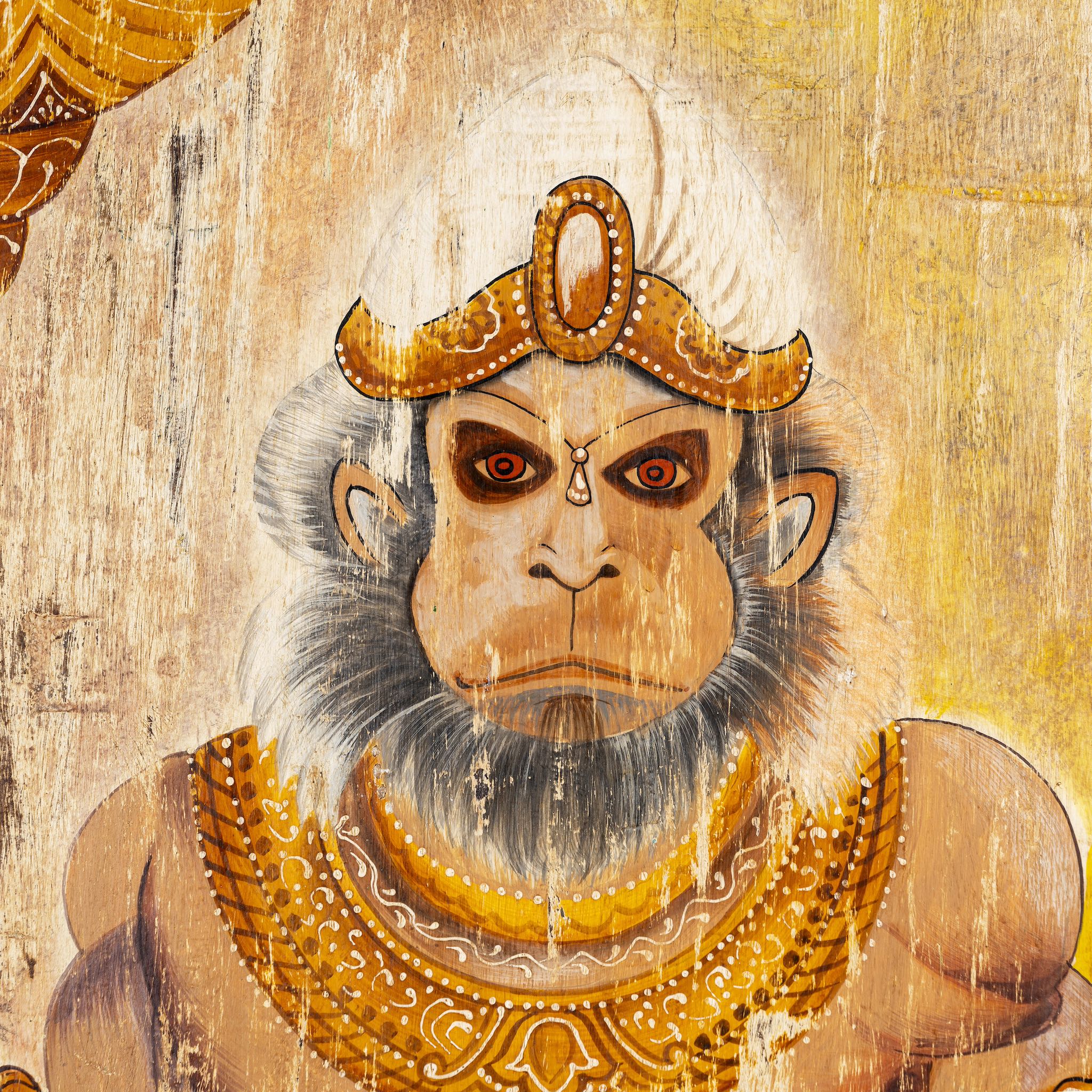 Close up image of a hand-painted vintage door panel measuring 54x3x195 cm, depicting the powerful figure of Lord Hanuman holding a golden mace, adorned in traditional attire with intricate jewelry, set against a distressed wooden background for an aged, sacred appearance.