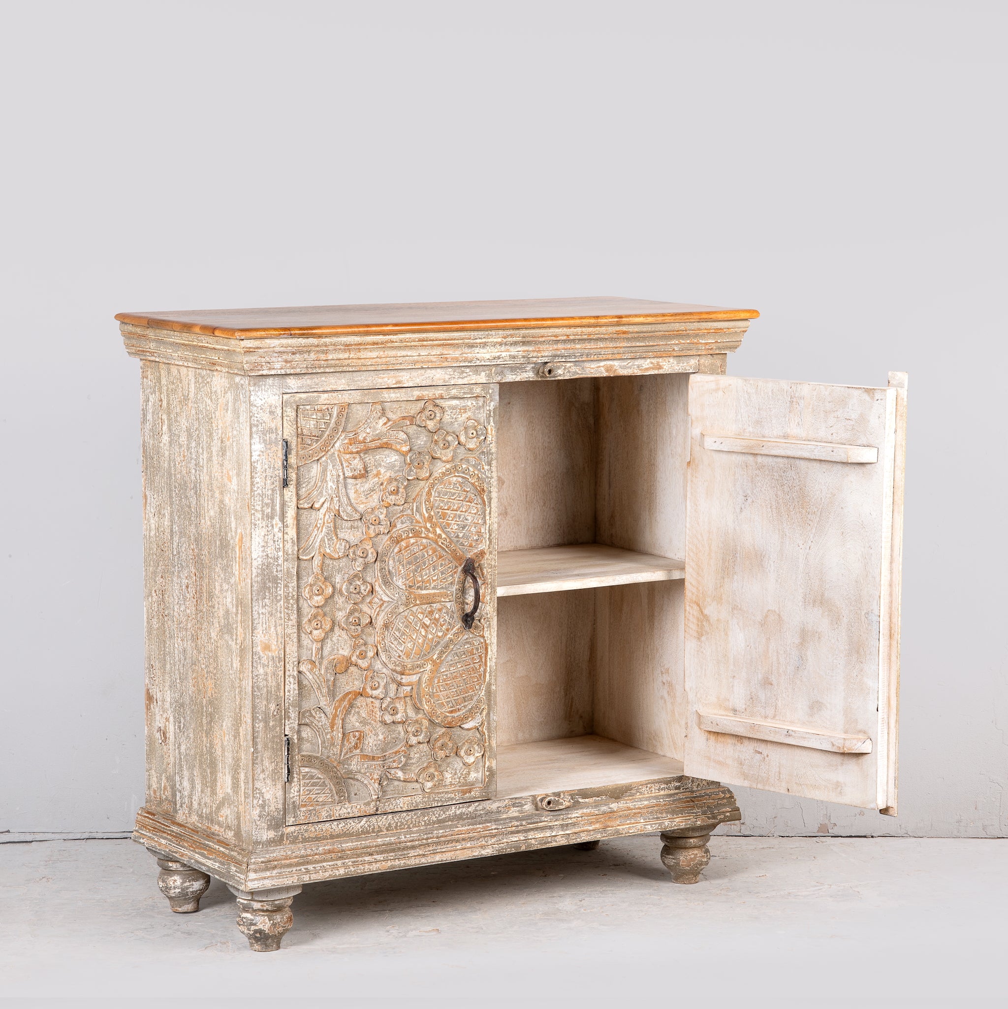 Image showing open door of a square carved wood sideboard with whitewashed floral detailing; ideal as living room furniture, 90 × 90 × 40 cm.