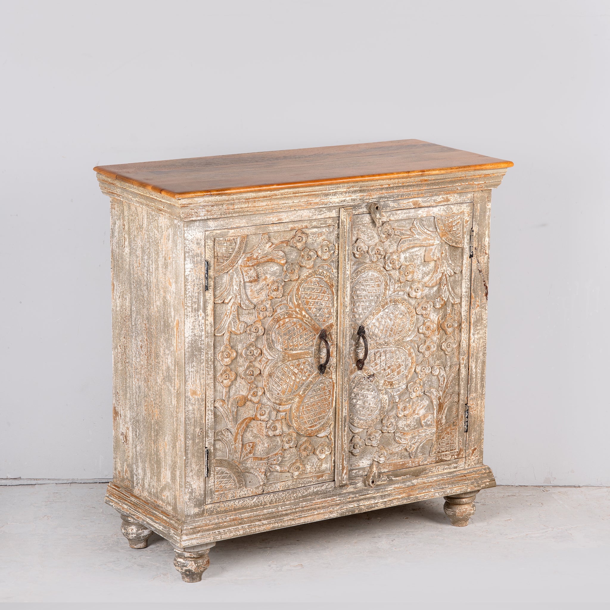 Side angle image of a square carved wood sideboard with whitewashed floral detailing; ideal as living room furniture, 90 × 90 × 40 cm.