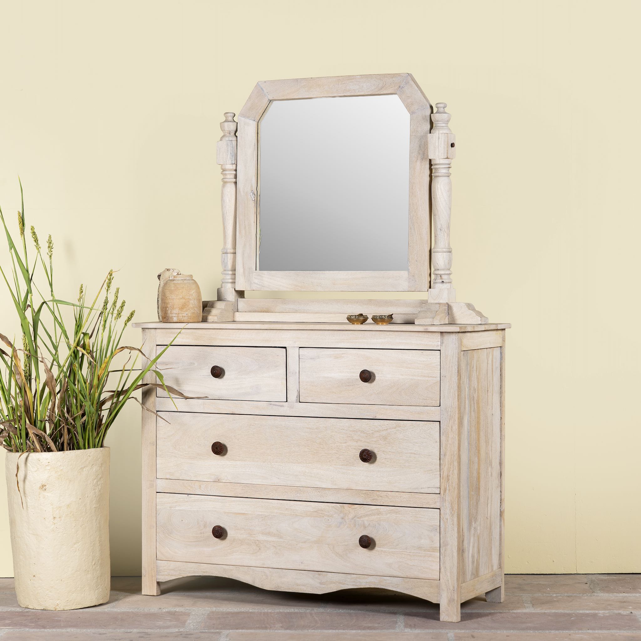 Side angle image of a Ibiza style Mango wood dressing table with five drawers and mirror, sandblasted whitewashed finish, 100 × 40 × 130 cm.