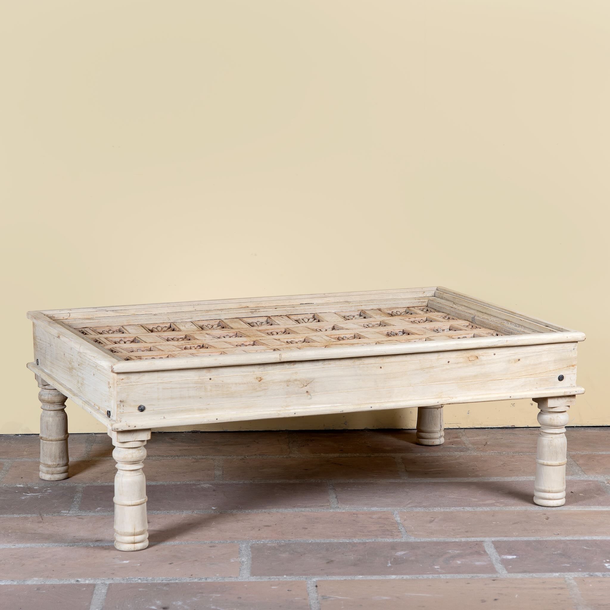 Jayson reclaimed teak wood coffee table with glass top, removable legs, and hand carved antique Indian ceiling panel.