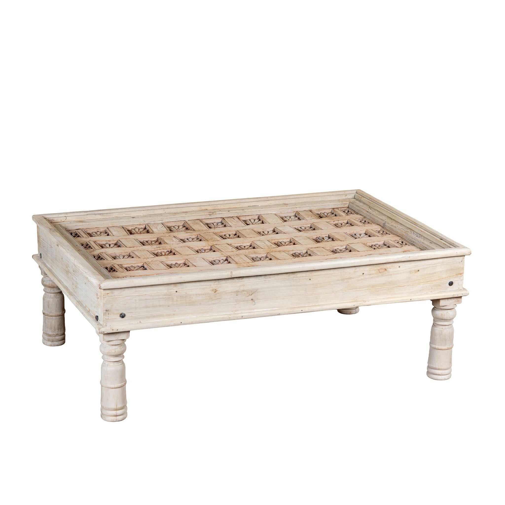 White background image of a Jayson reclaimed teak wood coffee table with glass top, removable legs, and hand carved antique Indian ceiling panel.