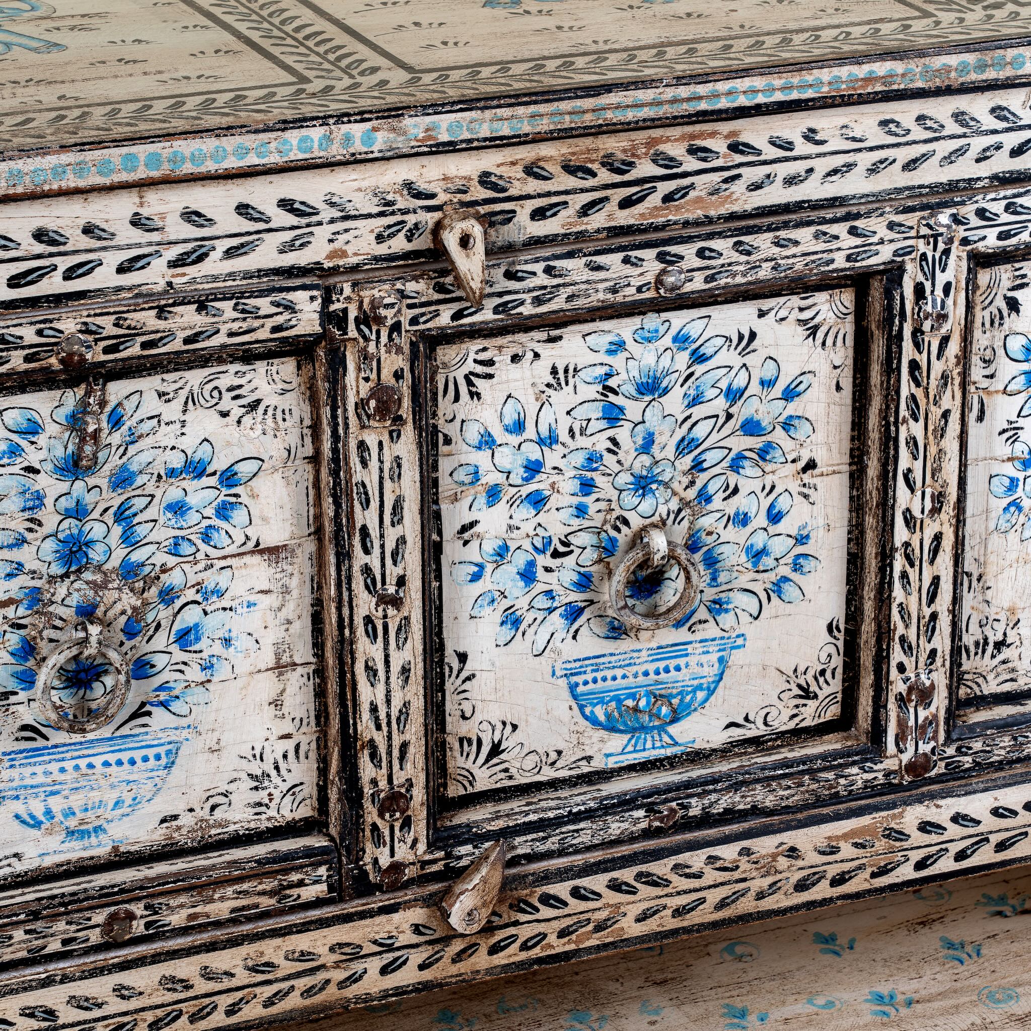 Close up image of a hand painted console table with 2 doors and plenty of inside storage made of reclaimed old wood in Boho style.