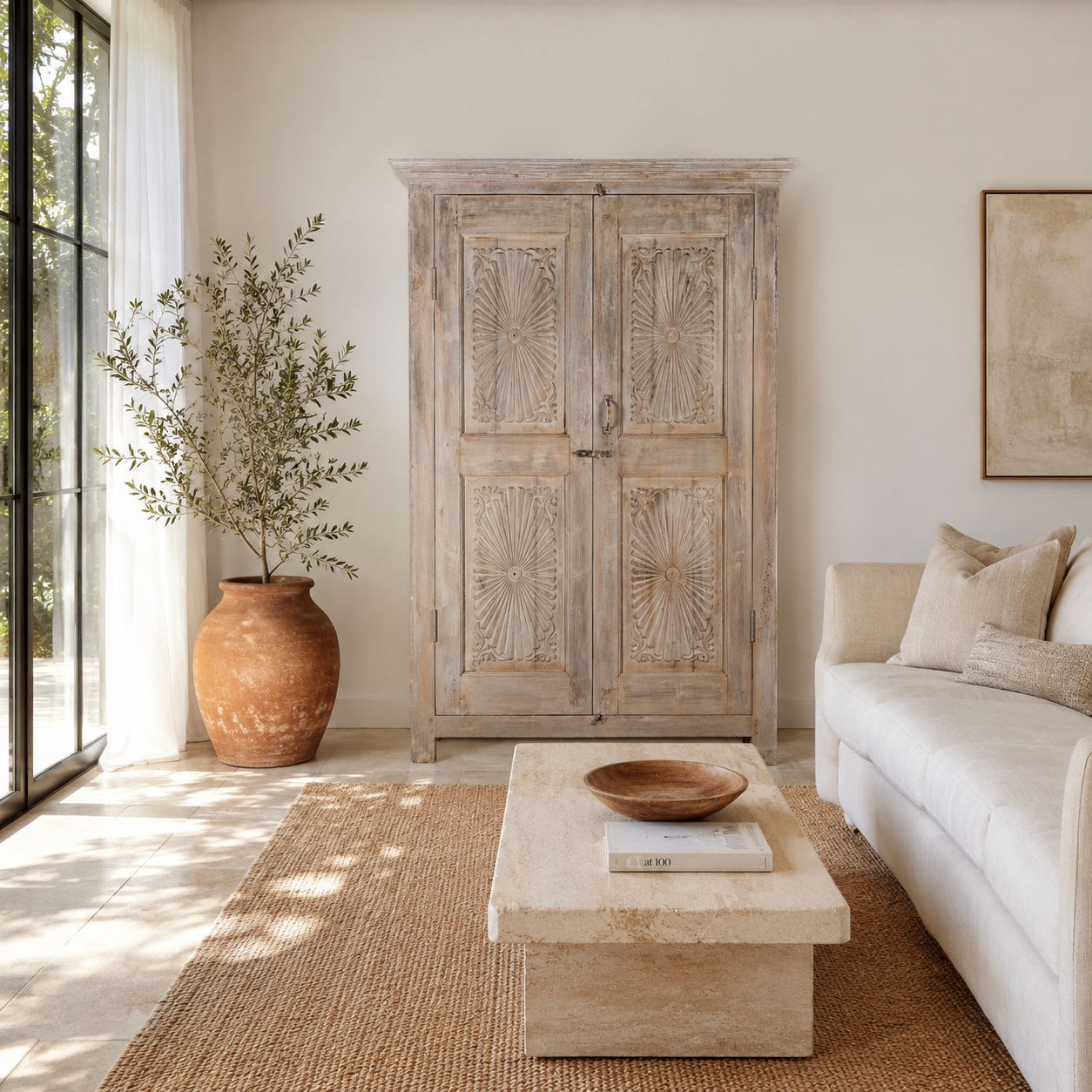 Lifestyle image of a Kaiden reclaimed teak wood wardrobe with hand-carved Indian details, double doors, and vintage whitewashed finish.