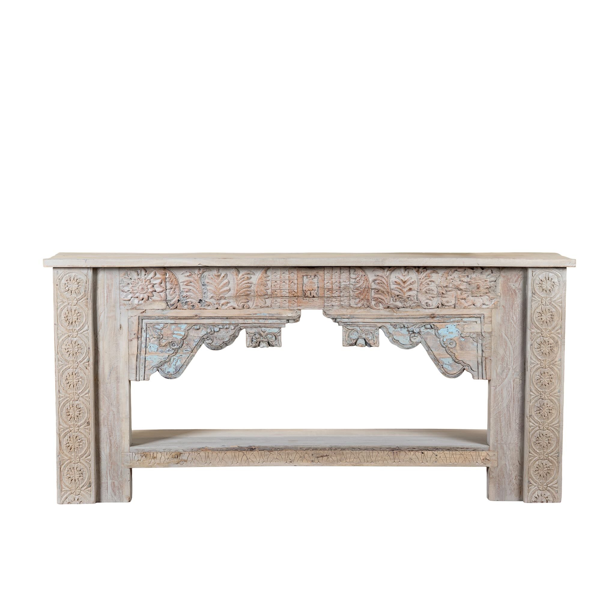 White background image of a Karam reclaimed teak console table with hand-carved Indian details, lower shelf, and vintage whitewashed finish.
