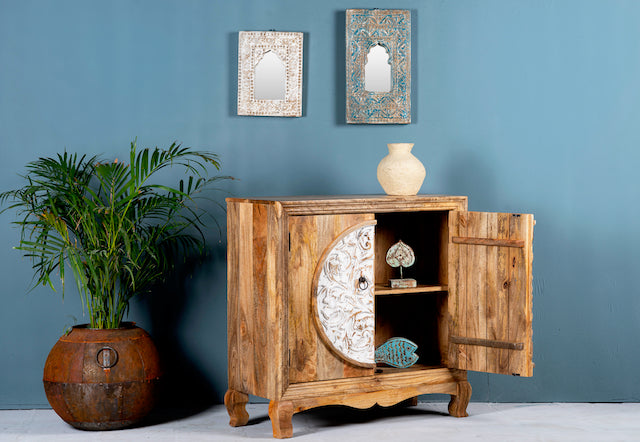 Side angle with open door image of a carved wood furniture cabinet made from mango wood with floral detailing and whitewashed finish, 90 × 90 × 40 cm.
