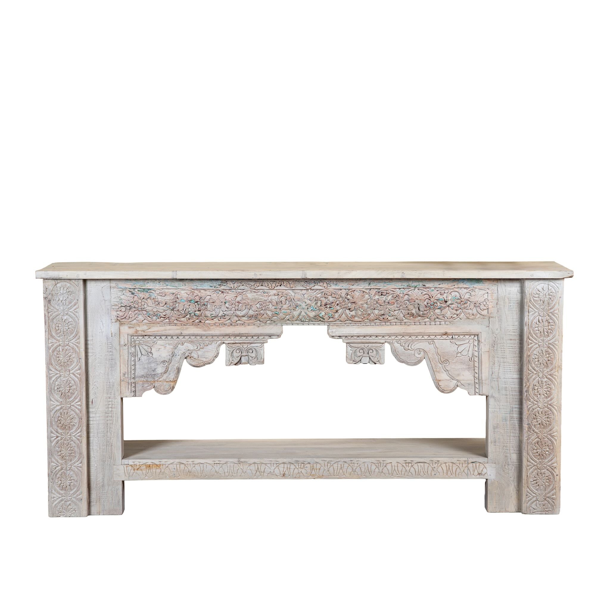White background image of a Kayleb reclaimed teak console table with hand-carved Indian floral details, lower shelf, and whitewashed vintage finish.