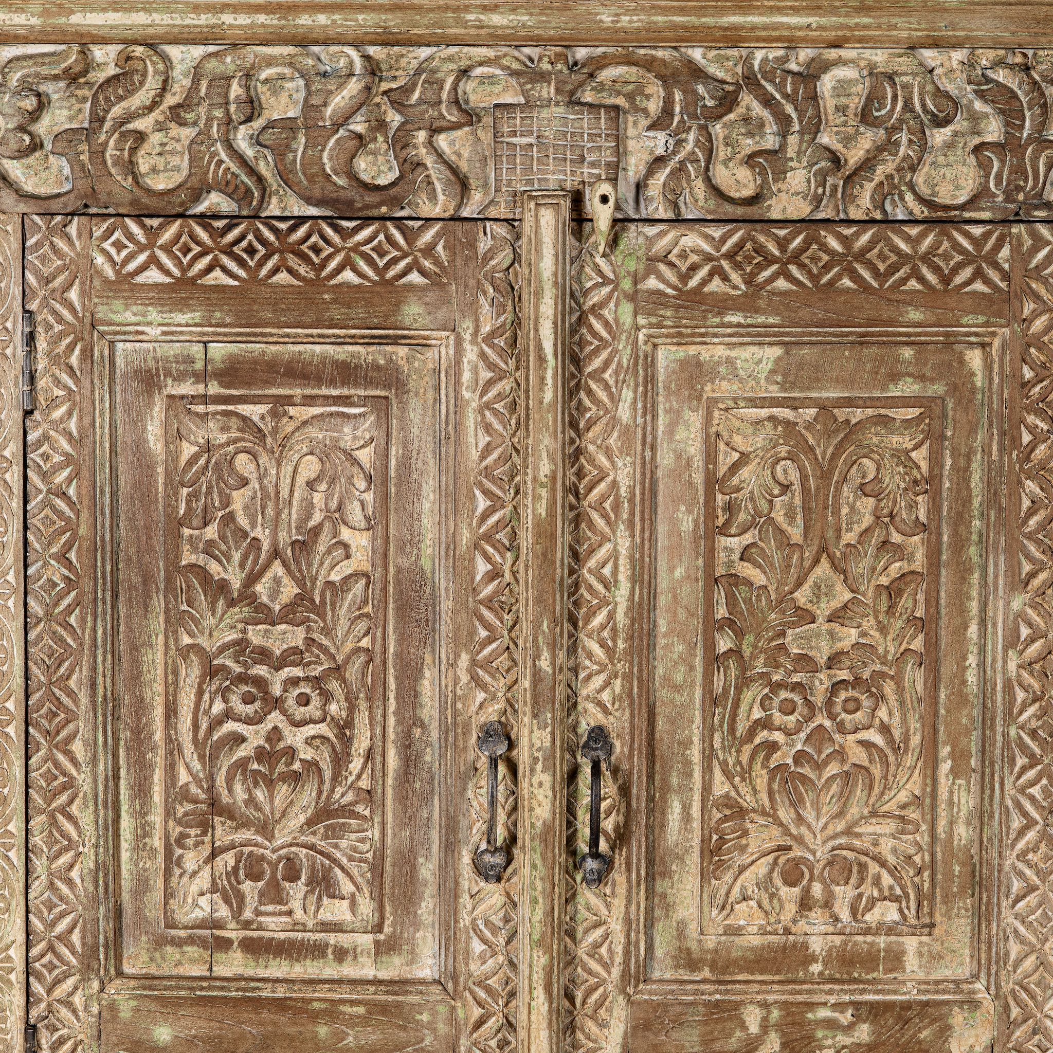 Close up image of a hand-carved reclaimed wood wardrobe with vintage finish – a sustainable furniture piece ideal for Indian home decor and rustic interiors.