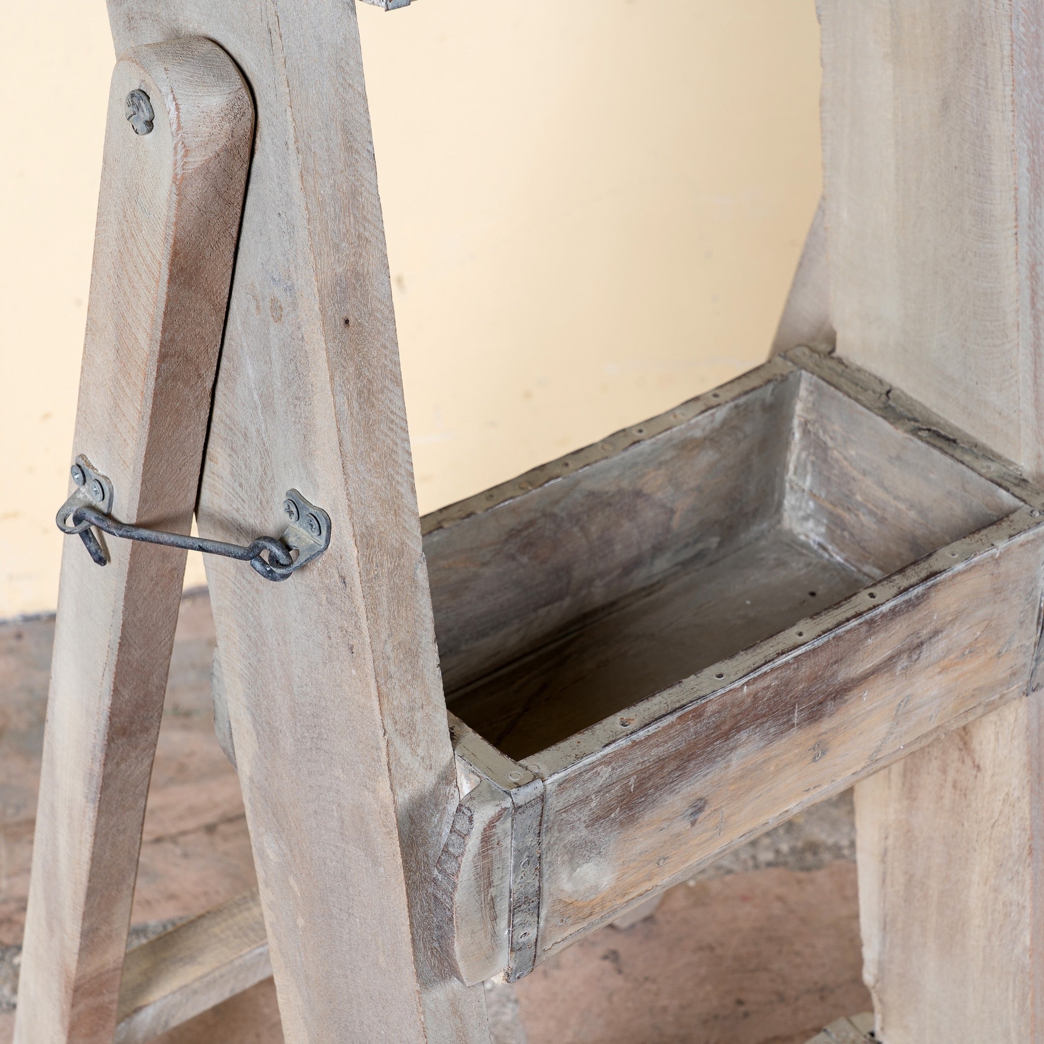 Close up image of a Liam reclaimed wood ladder shelf crafted from original Indian brick moulds with three storage compartments, 97cm