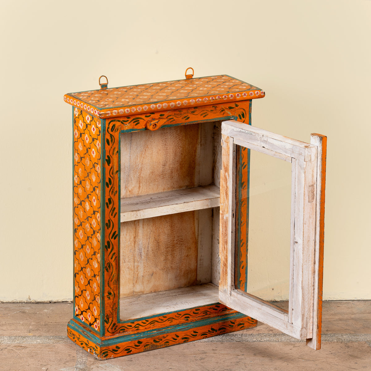 Image showing open door of a Lokesh hand-painted reclaimed wood wall cabinet with orange floral decoration, turquoise accents, glass door and interior shelf, 40x15x52cm