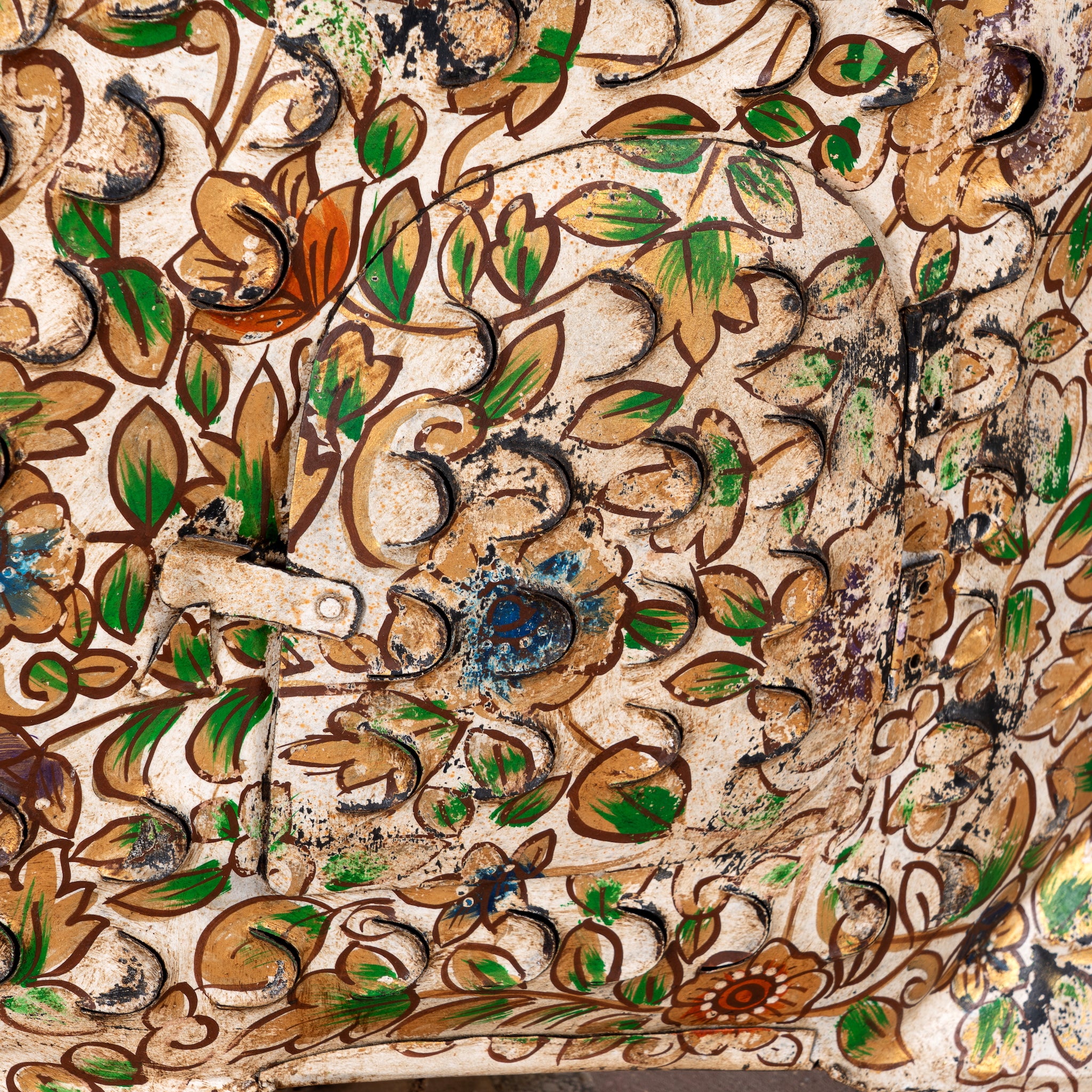 Close up image of a Malini hand painted freestanding metal fish sculpture with intricate floral artwork in soft green, cream and earthy tones, handcrafted decorative home accessory, 107x15x80cm.